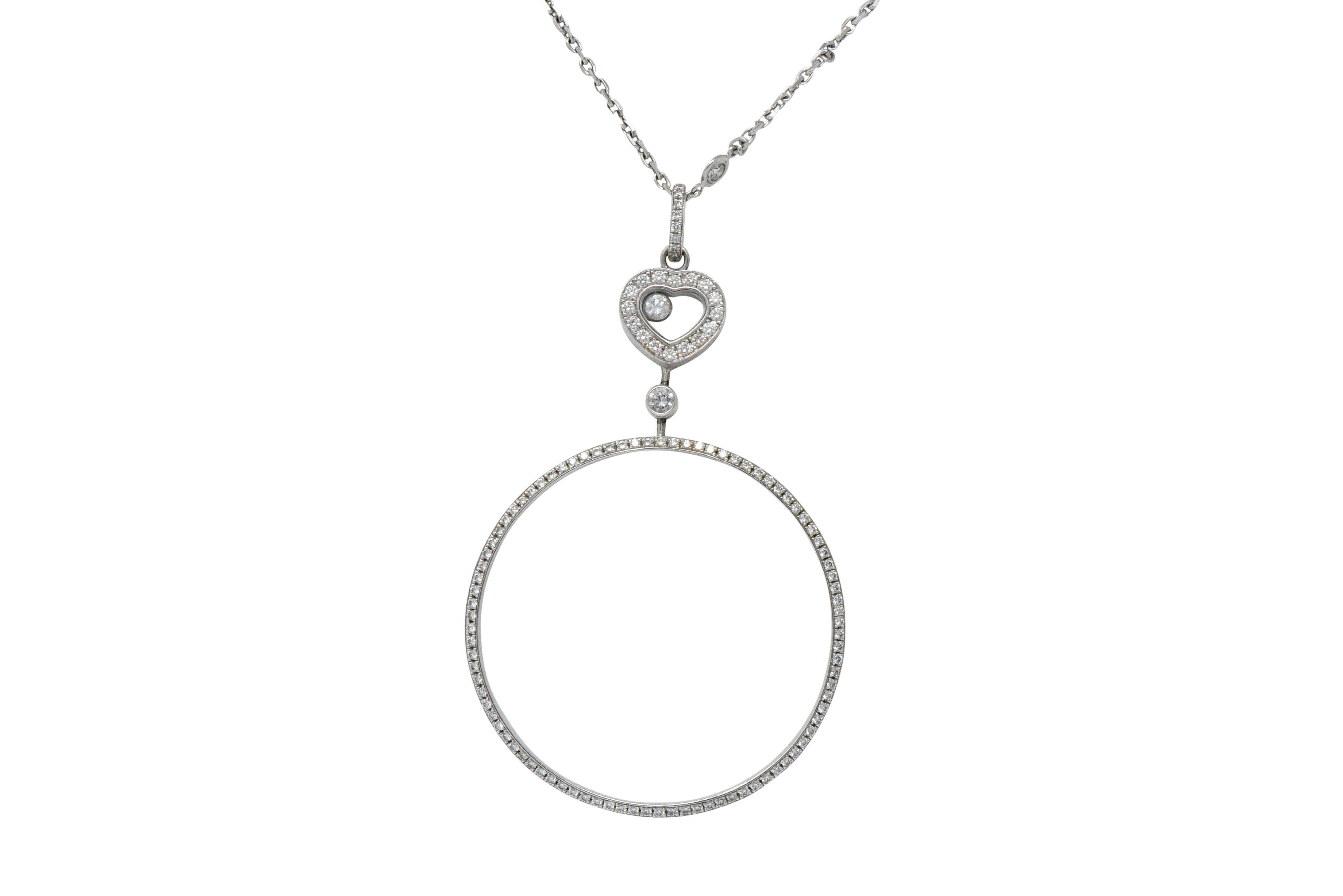 Pendant designed as a heart suspending a large open circle drop; heart accented by 