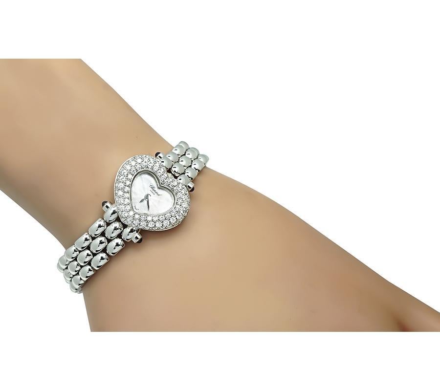 This is a gorgeous 18k white gold watch by Chopard. The watch is set with sparkling round cut diamonds that weigh approximately 1.43ct. The color of the diamonds is E-F with VS clarity. The case of the watch measures 19mm by 22mm. The watch measures