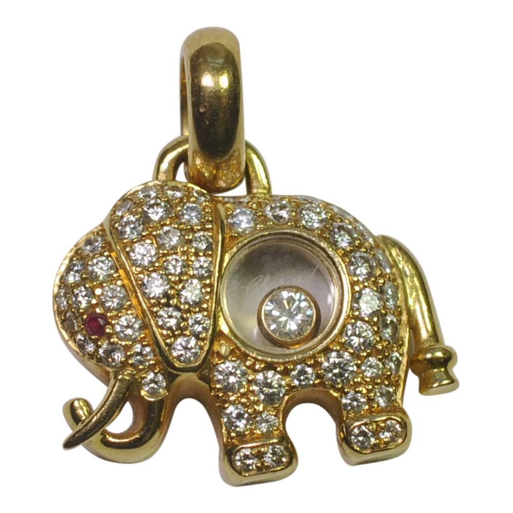 From the iconic Chopard Happy Diamonds range, comes this adorable Happy Elephant pendant in 18ct gold, pavé set brilliant cut diamonds and accented with a ruby eye.  This cute little guy has a floating diamond inside him and is set with 0.75ct of