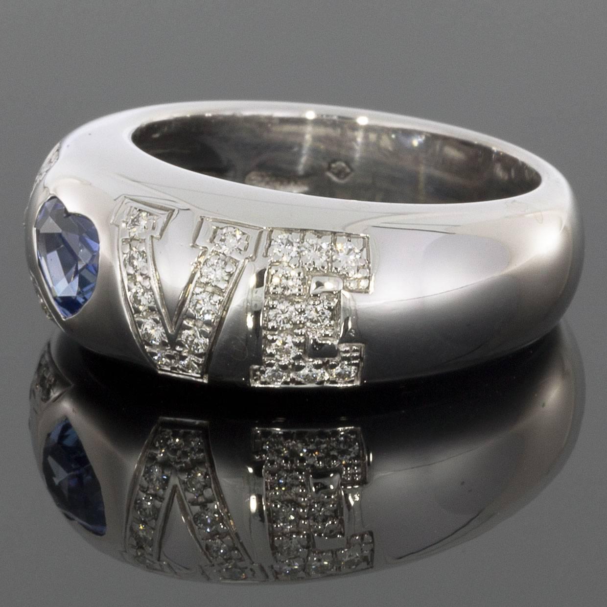 This Chopard LOVE ring is a 18k white gold band set with diamonds and a sapphire spelling the word 