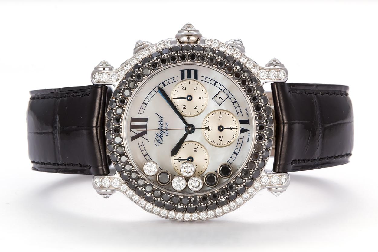 We are pleased to offer this Chopard 18k White Gold & Diamond Happy Sport 28/3340-50. This watch features a brand new Chopard leather strap, quartz movement, mother-of-pearl dial with Roman numerals and outer minute track, blued steel hands,