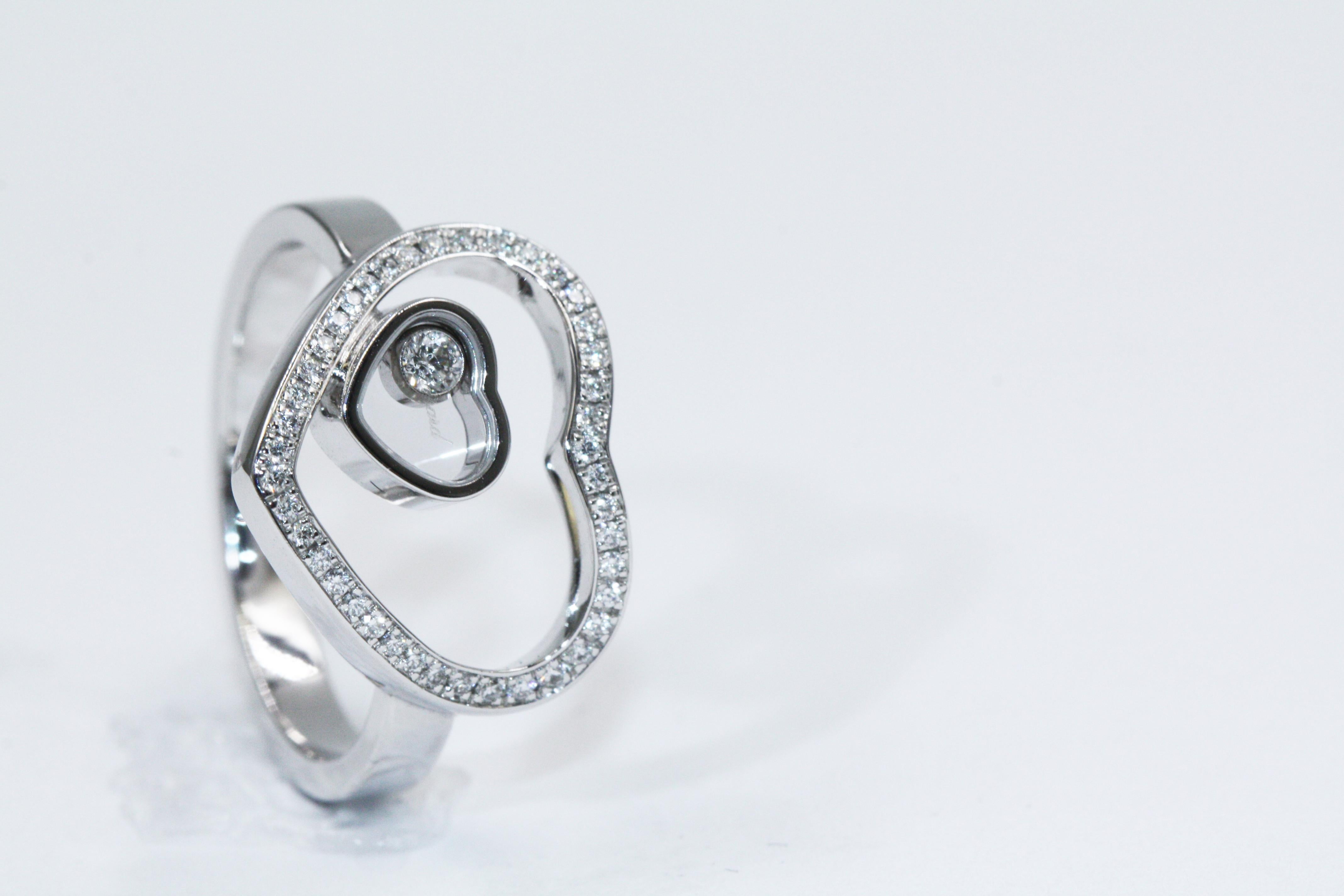 At the heart of a heart, this Happy Diamonds Ring is as iconic as it is timeless, with its moving diamond gently dancing and twirling. 
Browse the freely moving diamond held between two sapphire crystals on the heart shaped motif creating a dance of
