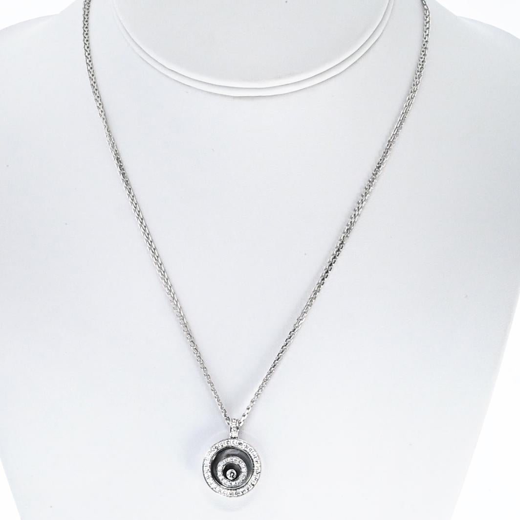 Elegant and playful, this Chopard *Happy Spirit* necklace is crafted in 18K white gold and showcases the brand’s signature floating diamond design. The round pendant features a sparkling array of diamonds totaling approximately 0.62 carats,