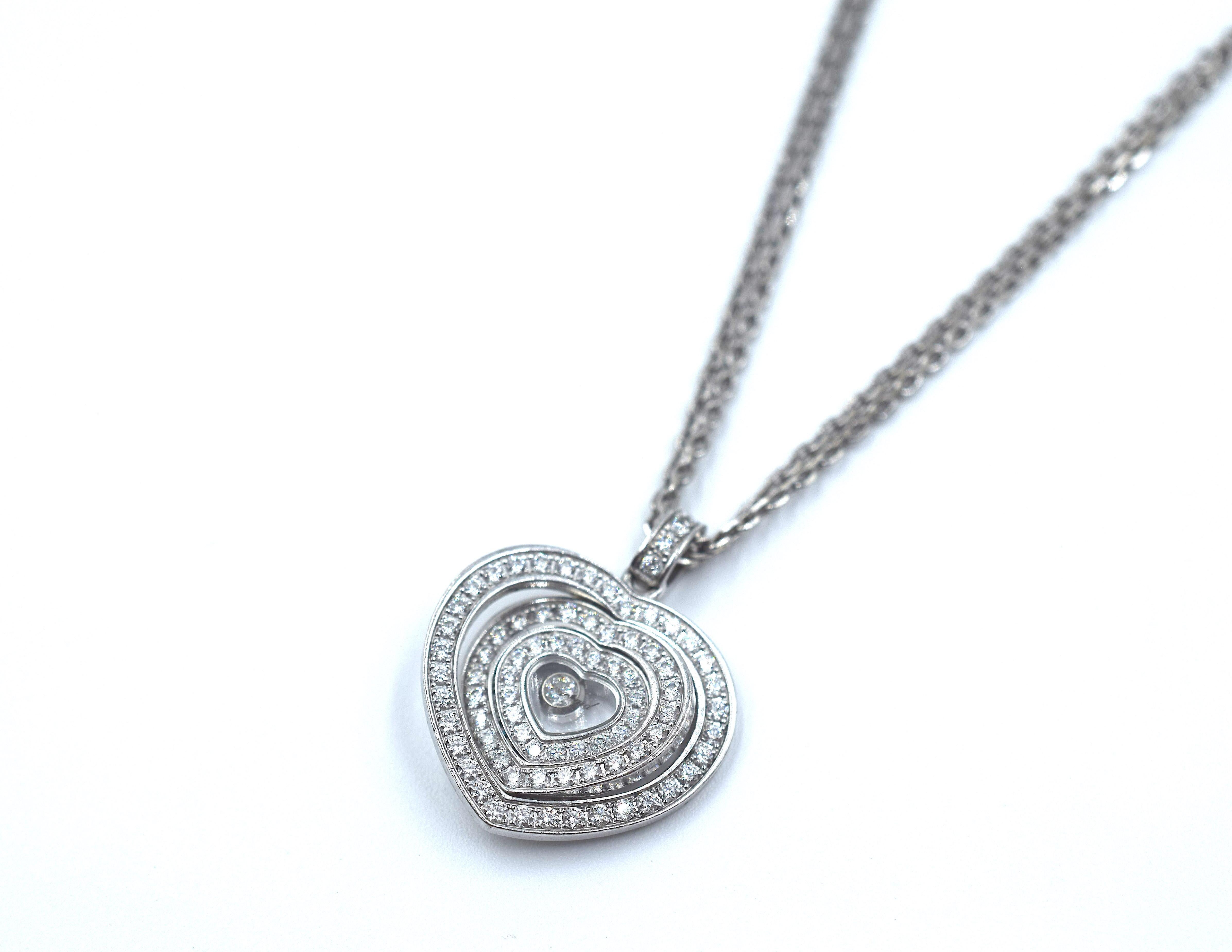 This amazing pendant from Chopard's Happy Spirit collection. Three diamond set heart shape frames decrease in size towards the central single iconic floating diamond. Crafted in all 18k white gold with a18k white gold double strand chain running
