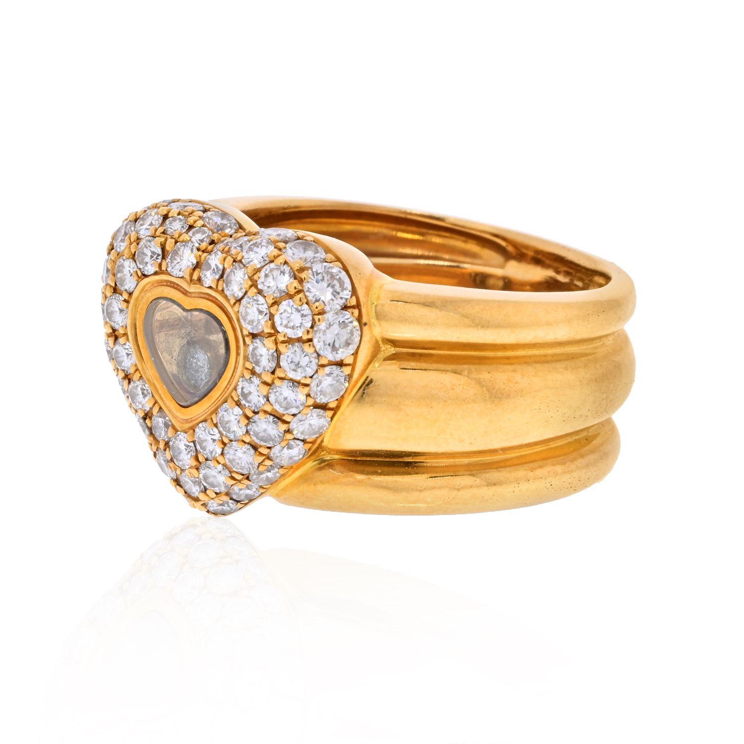  This vintage Chopard 18K Yellow Gold Pave Heart Shape Floating Diamond Ring is mounted with one diamond behind the crystal and round cut pave set diamonds in three rows around the center heart frame 0.59cttw.
Ring will be given a nice polish before