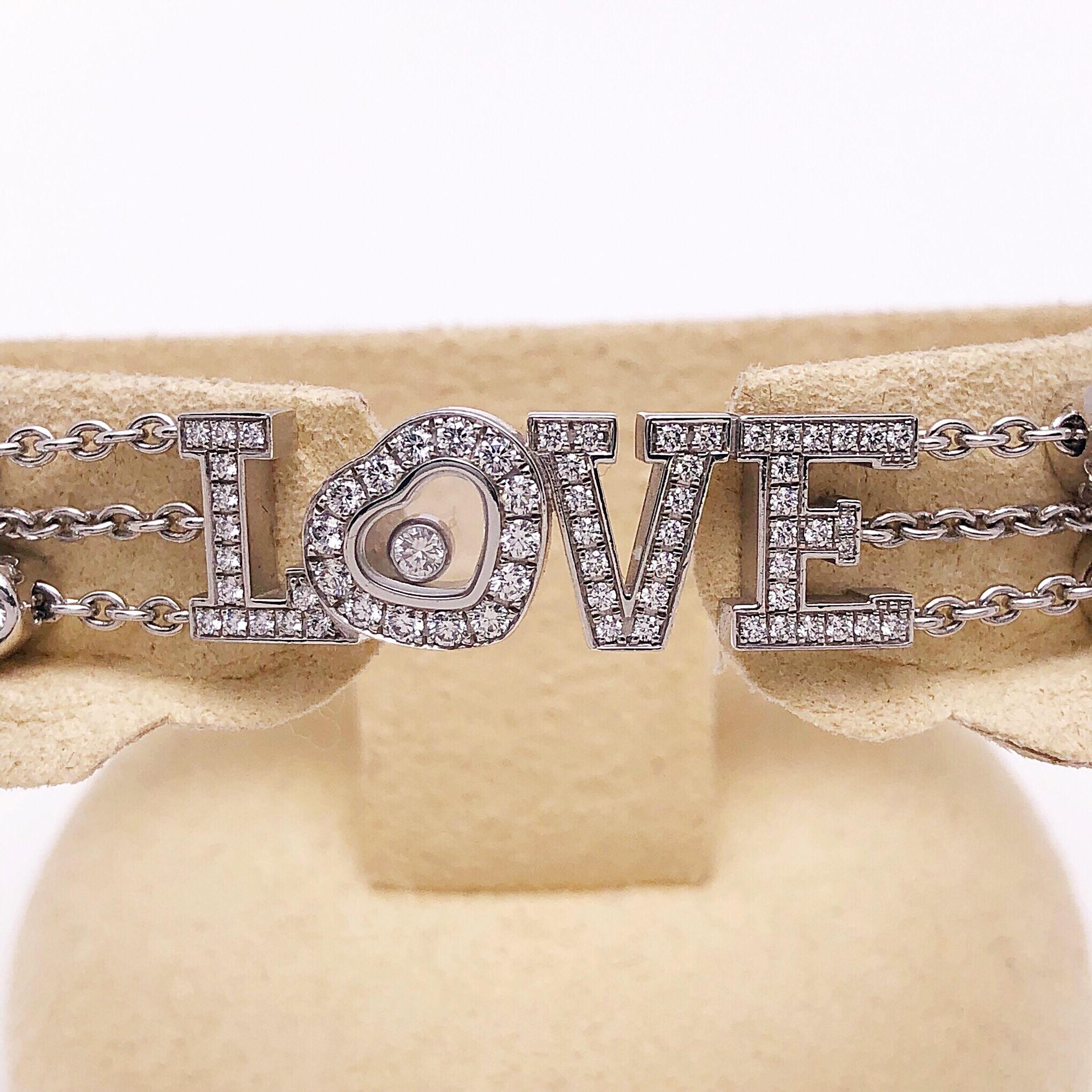 Designed by Chopard ,this bracelet features a full diamond center LOVE along with three chains sprinkled with 10 diamond hearts. A single floating diamond is in the center of the heart shaped letter O. There are 95 diamonds with a total diamond