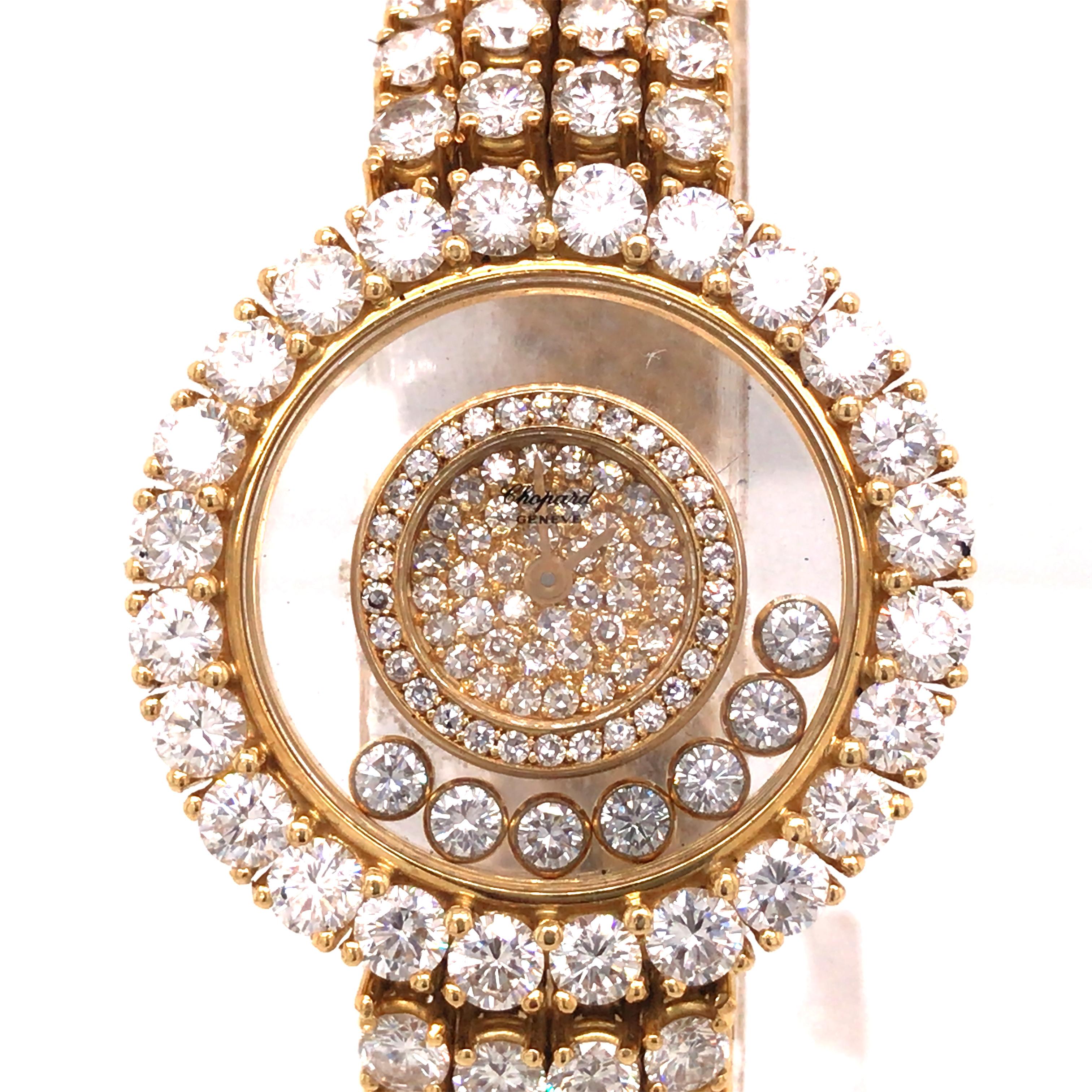 Chopard 24 Carat Happy Diamond Watch in 18K Yellow Gold.  Round Brilliant Cut Diamonds weighing 24 carat total weight, D-E in color and VVS2 in clarity are expertly set in the band, bezel and inside the face of the watch.  The watch measures 7 in