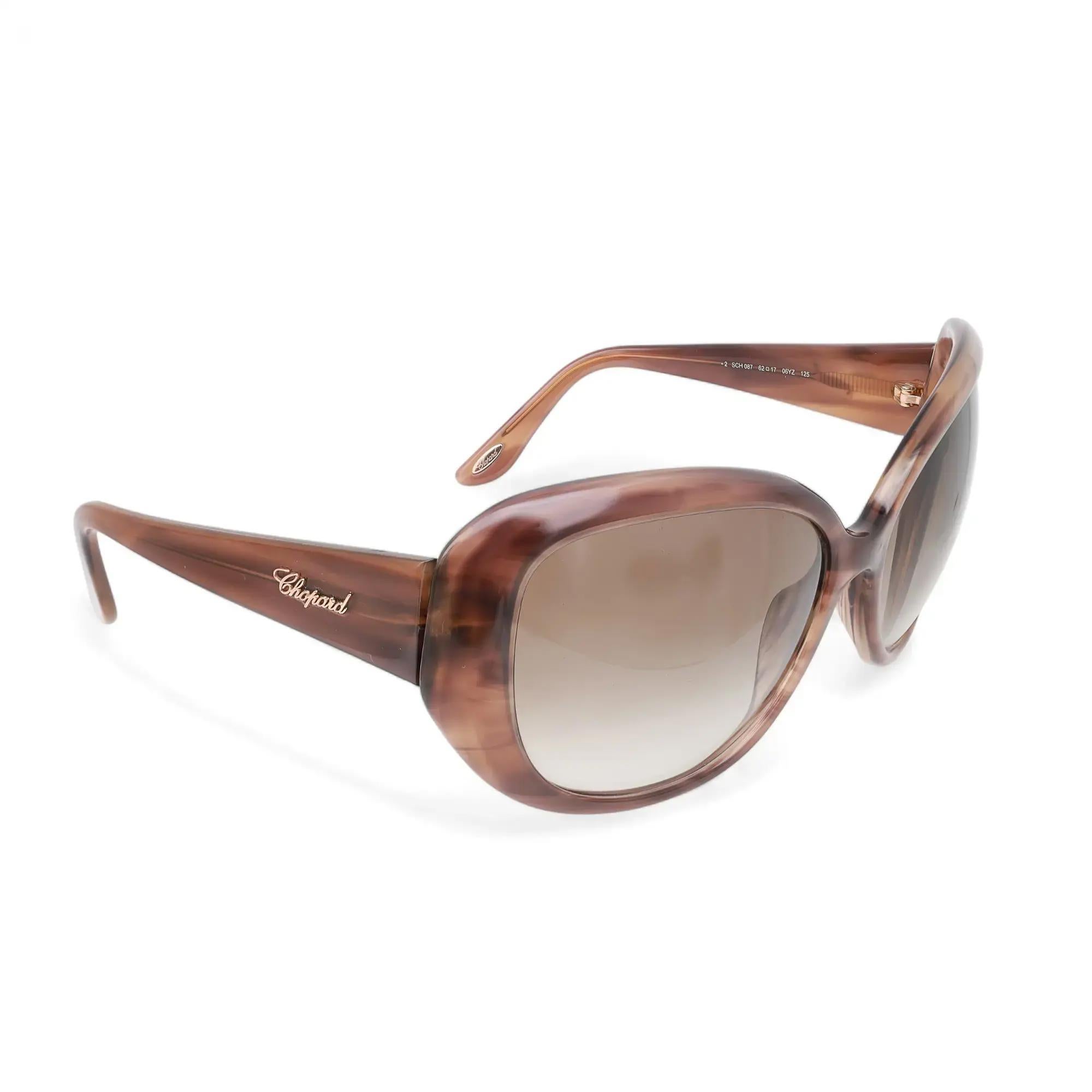 Ti presentiamo i lussuosi occhiali da sole unisex Chopard 95221-0147, perfetti per la moda di strada. Questi occhiali da sole presentano una montatura in acetato beige a righe con lenti cammello sfumate. Le braccia sono ornate con eleganza dal logo