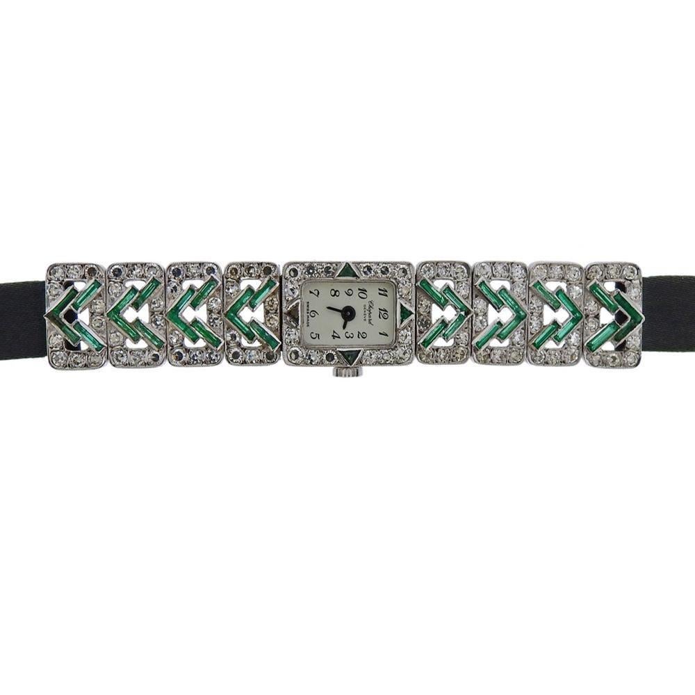 Art Deco 18k white gold Chopard lady's dress watch. Featuring diamonds and emerald on case and lugs. Satin black band - 6.25