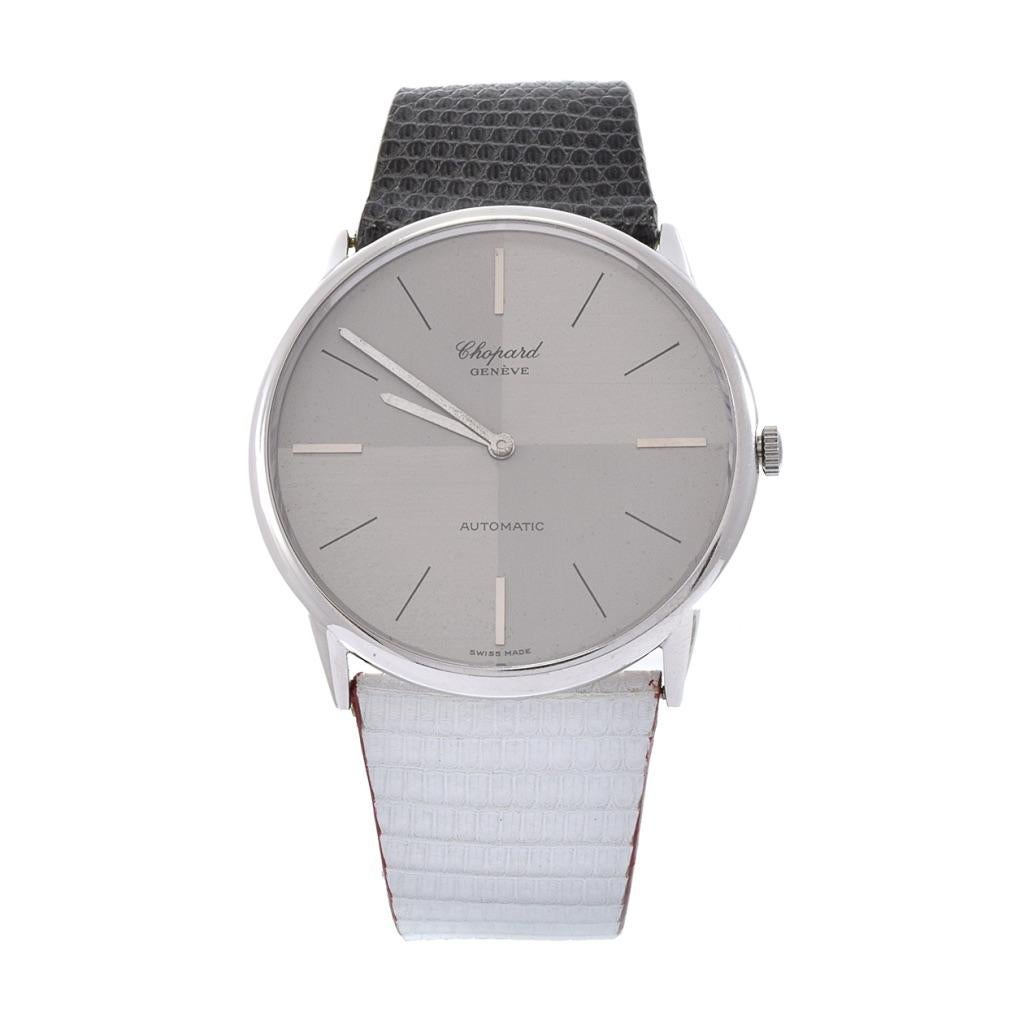 Introducing the Chopard 50105/1027 vintage 1980's wristwatch, a timeless embodiment of elegance and luxury. This exquisite timepiece features a 41mm round 18kt white gold case with a classic angled grey dial, adding a unique touch to its design. The
