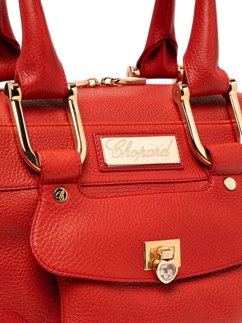 Crafted in Italy, this pre-owned bag comes in a lovely shade of red. The Caroline is part of the brand's iconic Happy Diamond collection, as you can tell by the small heart-shaped charm on the front pocket, this bag features a canvas interior, stud