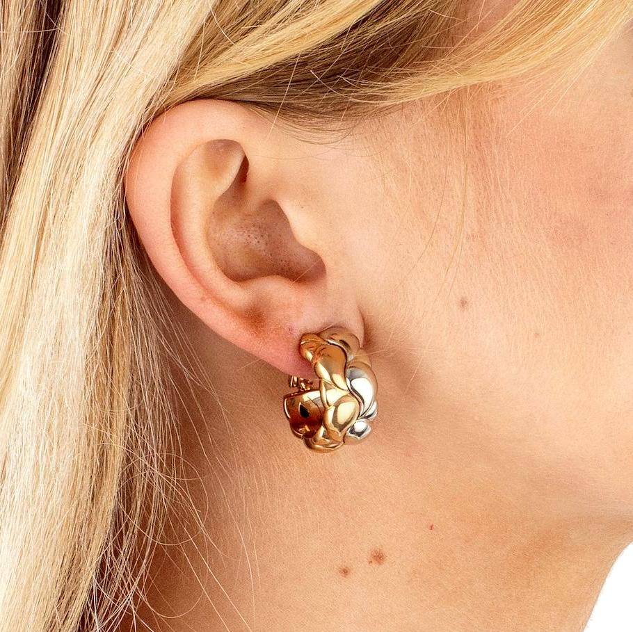 Chopard earrings from the Casmir collection circa 1990s showcasing a paisley motif in 18k white and yellow gold. The earrings measure .86