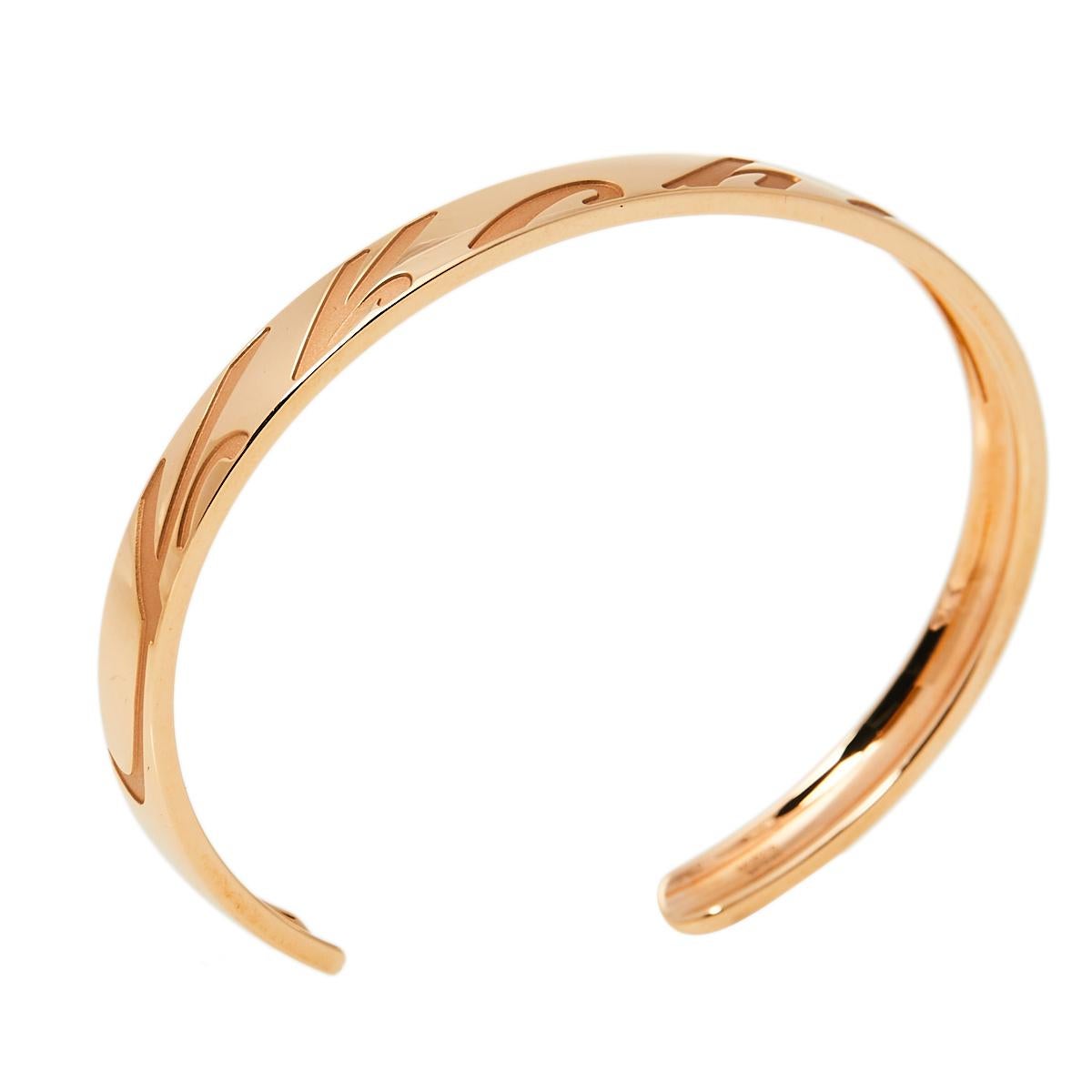 This creation from Chopard speaks luxury in a way that is minimal and elegant. The bracelet has been excellently crafted from 18k rose gold in an open cuff style. Set beautifully on the bracelet are cursive engravings of the brand's name, a