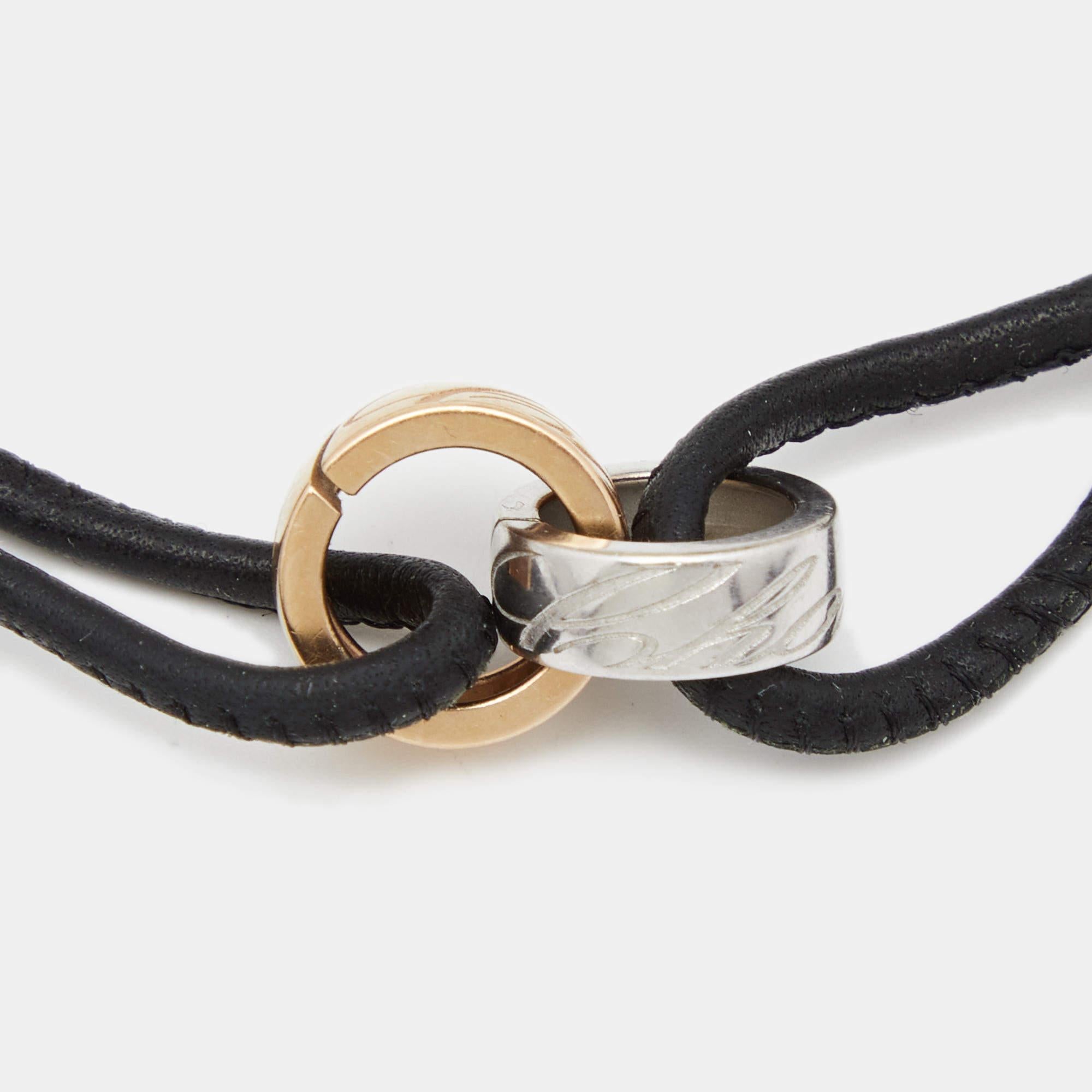 This Chopard Chopardissimo bracelet presents an elegant, simple style. It has an adjustable black leather cord that holds two engraved rings in 18k gold.

