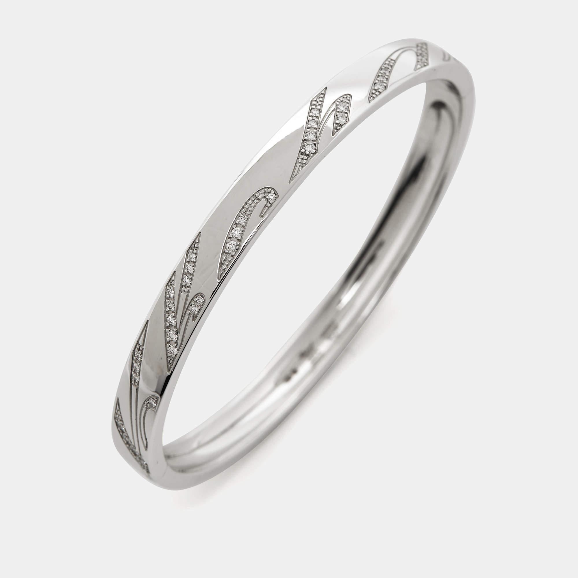 This creation from Chopard speaks luxury in a way that is minimal and elegant. The bracelet has been excellently crafted from 18k white gold in a bangle style. Set beautifully on the bracelet are cursive engravings of the brand's name—a signature of
