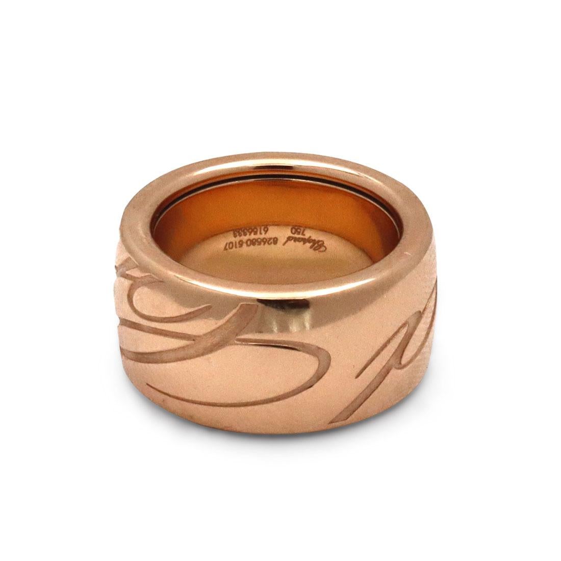 Authentic Chopard ring from the 'Chopardissimo' collection crafted in 18 karat rose gold.  The bold curves of the ring are highlighted by the caligraphy of the Chopard logo.  The ring measures 11mm in width and is a US size 5 1/2.  Signed Chopard,