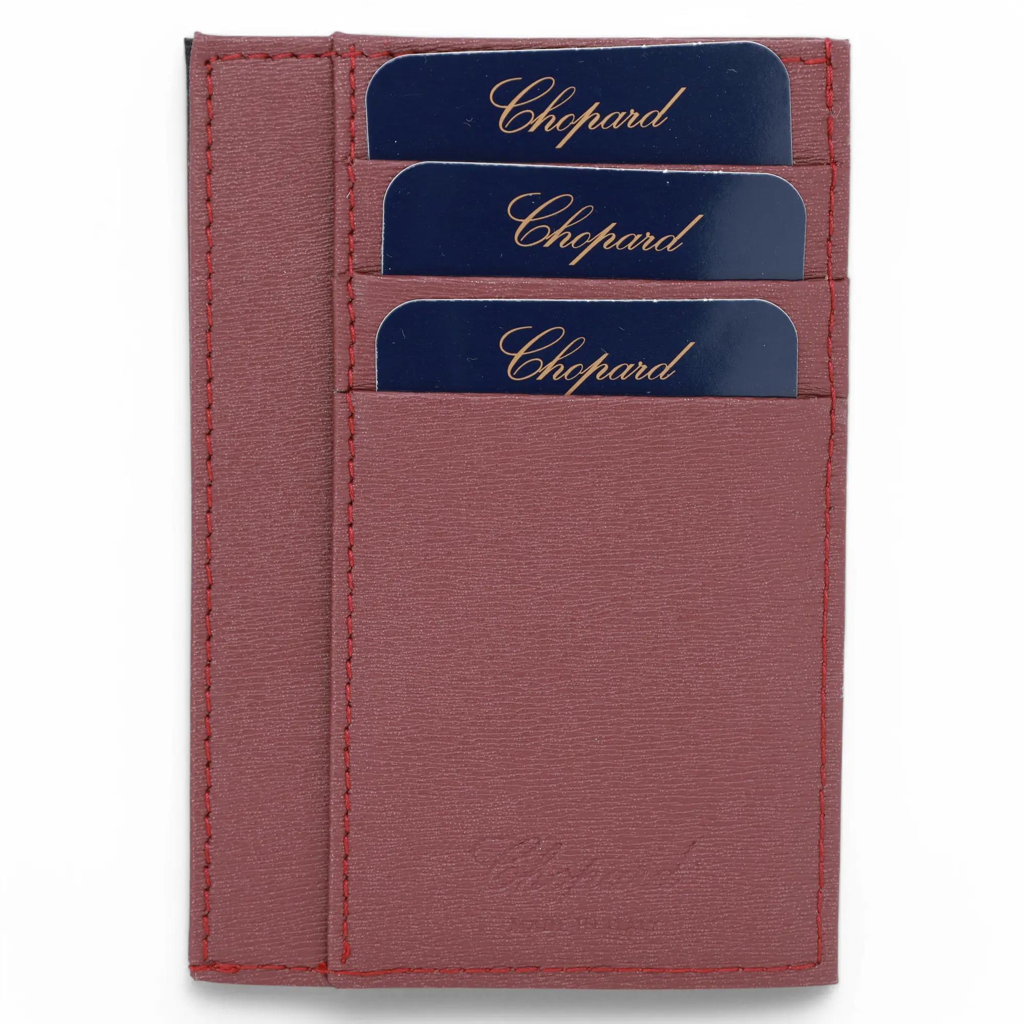 Chopard Classic Bordeaux Grained Leather Large Card Holder. This super compact card holder features card slots and bill compartments with silver tone hardware Chopard logo on front. It measures 4 inches x 3.5 inches. New without tags. Original box