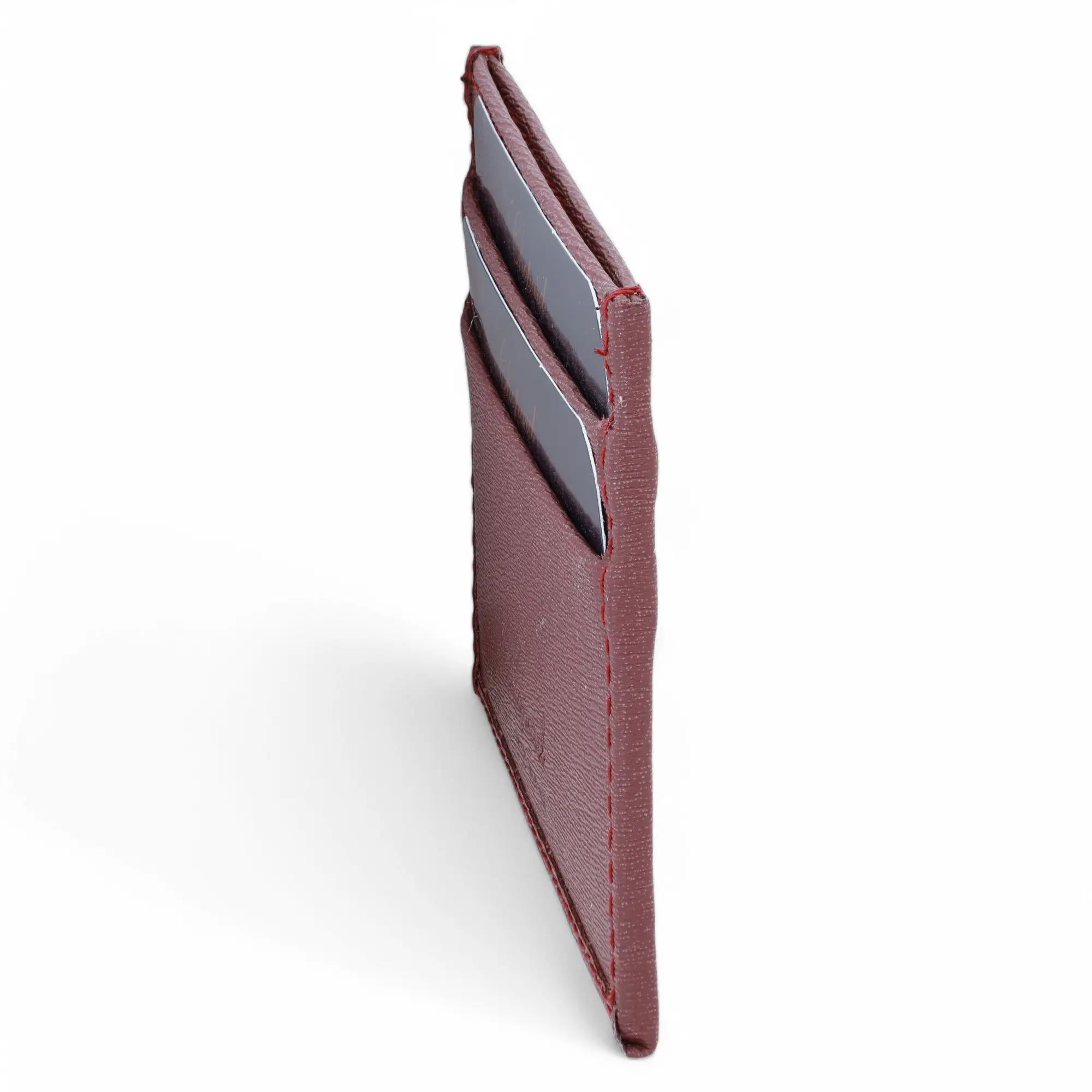 Chopard Classic Bordeaux Grained Leather Small Card Holder. This super compact card holder features card slots with silver tone hardware Chopard logo on front. It measures 4 inches x 3 inches. New without tags. Original box and dust bag are