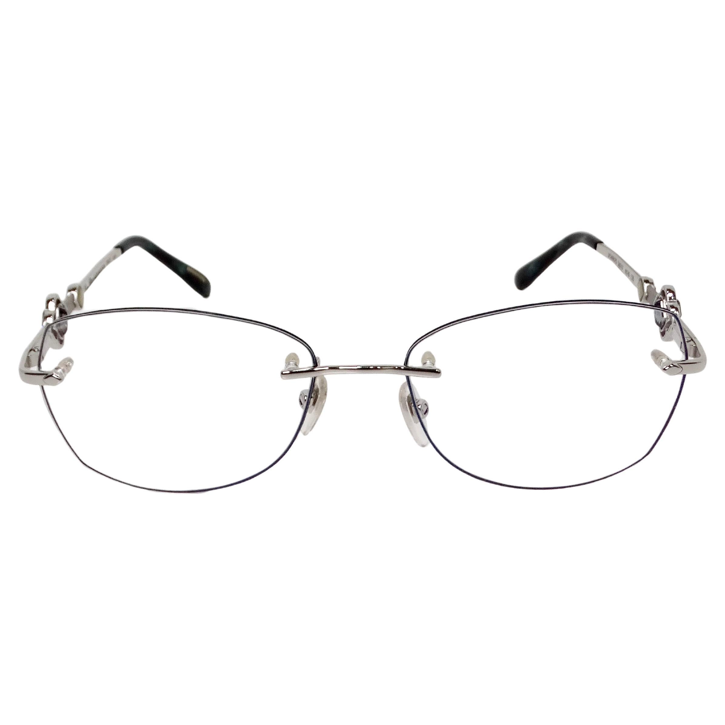 The Chopard Clear Frameless Silver-Tone Metal Eyeglasses with Crystal Accents epitomize understated elegance and sophisticated style. The frameless design offers a lightweight, barely-there feel, making them perfect for those who prefer a minimalist