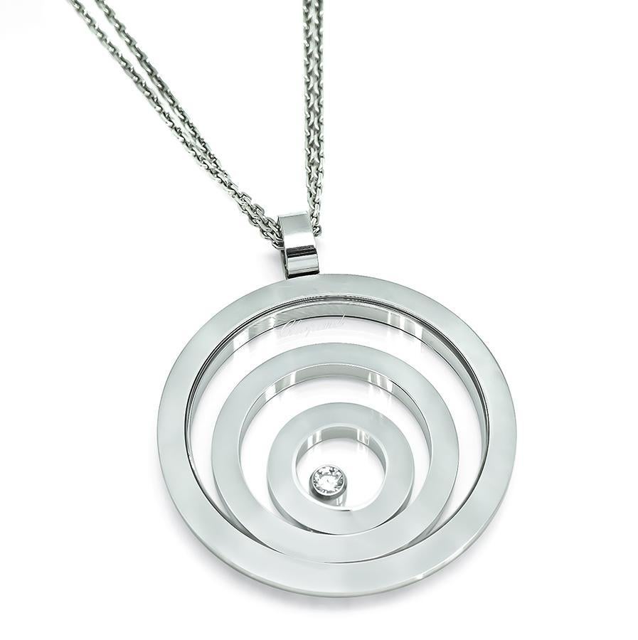 This is an elegant 18k white gold pendant necklace from Happy Spirit collection by Chopard. The pendant is set with sparkling round cut diamond accent. The pendant measures 39mm by 32mm. The chain measures 16.5 inches in length. The necklace is