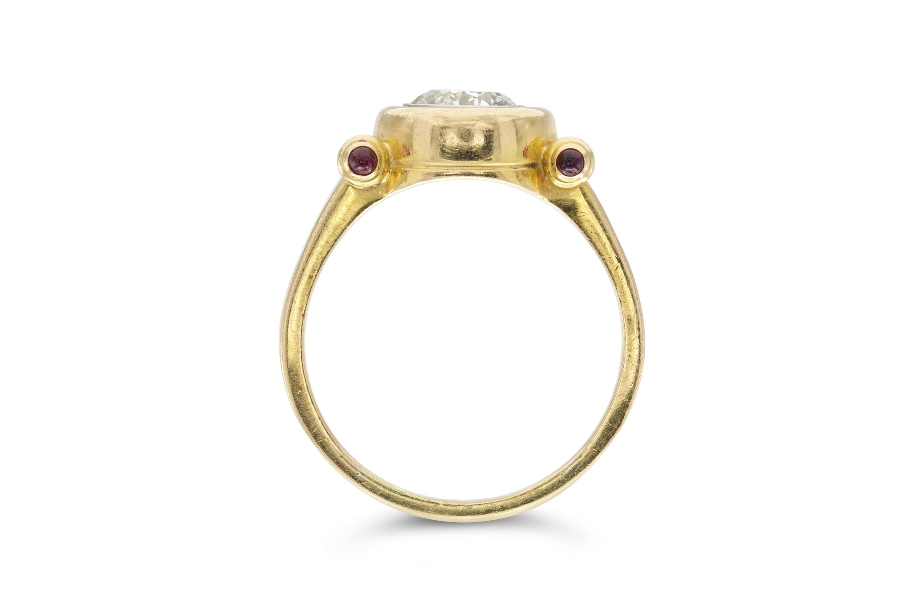 Finely crafted in 18K yellow gold featuring a center diamond weighing 1.90 carat with color J and VS1 clarity. The ring also features four small rubies.
Size 9 3/4, resizable.