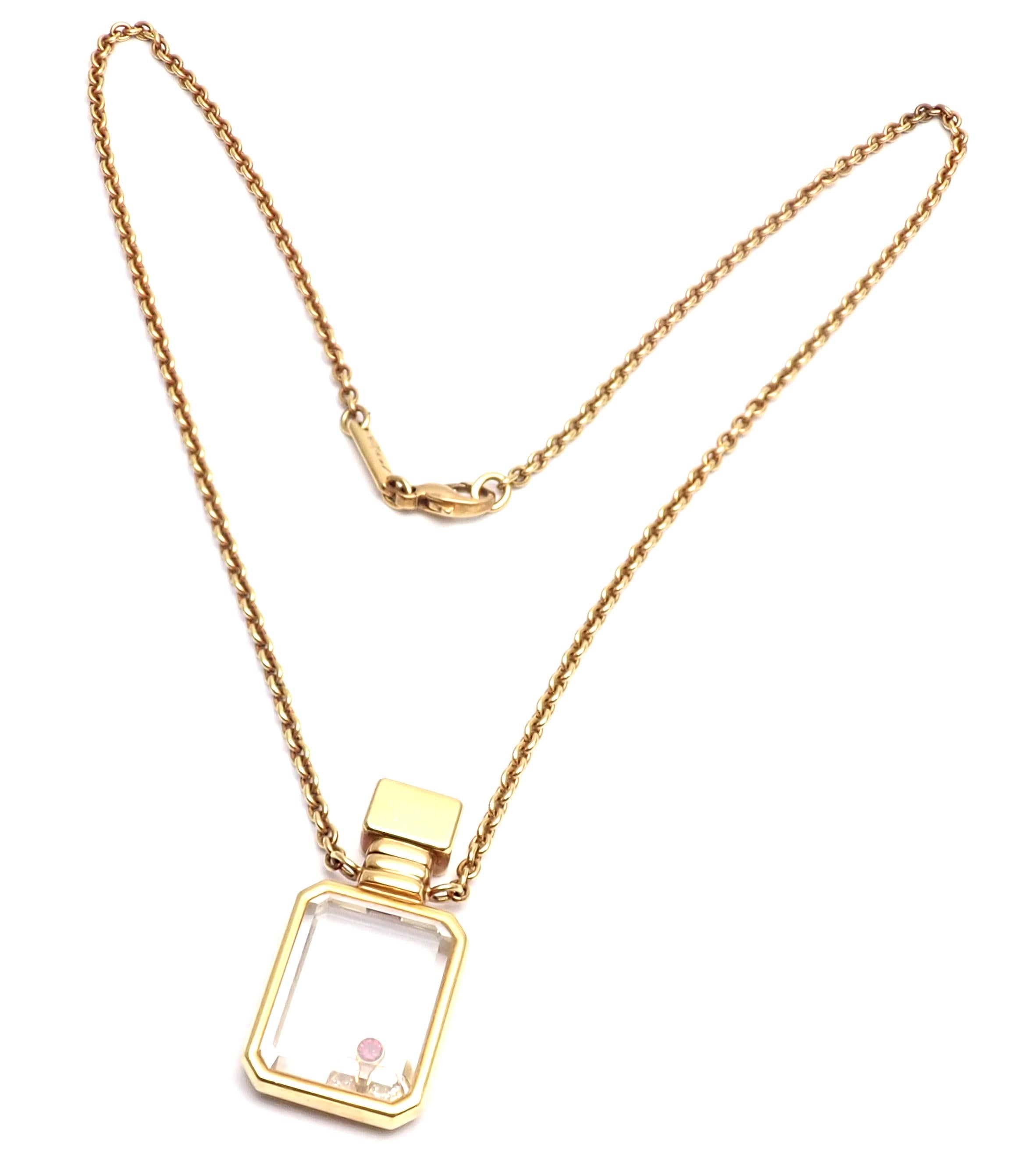 18k Yellow Gold Diamond Ruby Happy Bottle Pendant Necklace by Chopard. 
With 2 Round Brilliant Cut Diamonds VS1 total weight approx. .11ct
1 round ruby
Measurements: 
Necklace Length: 16.5