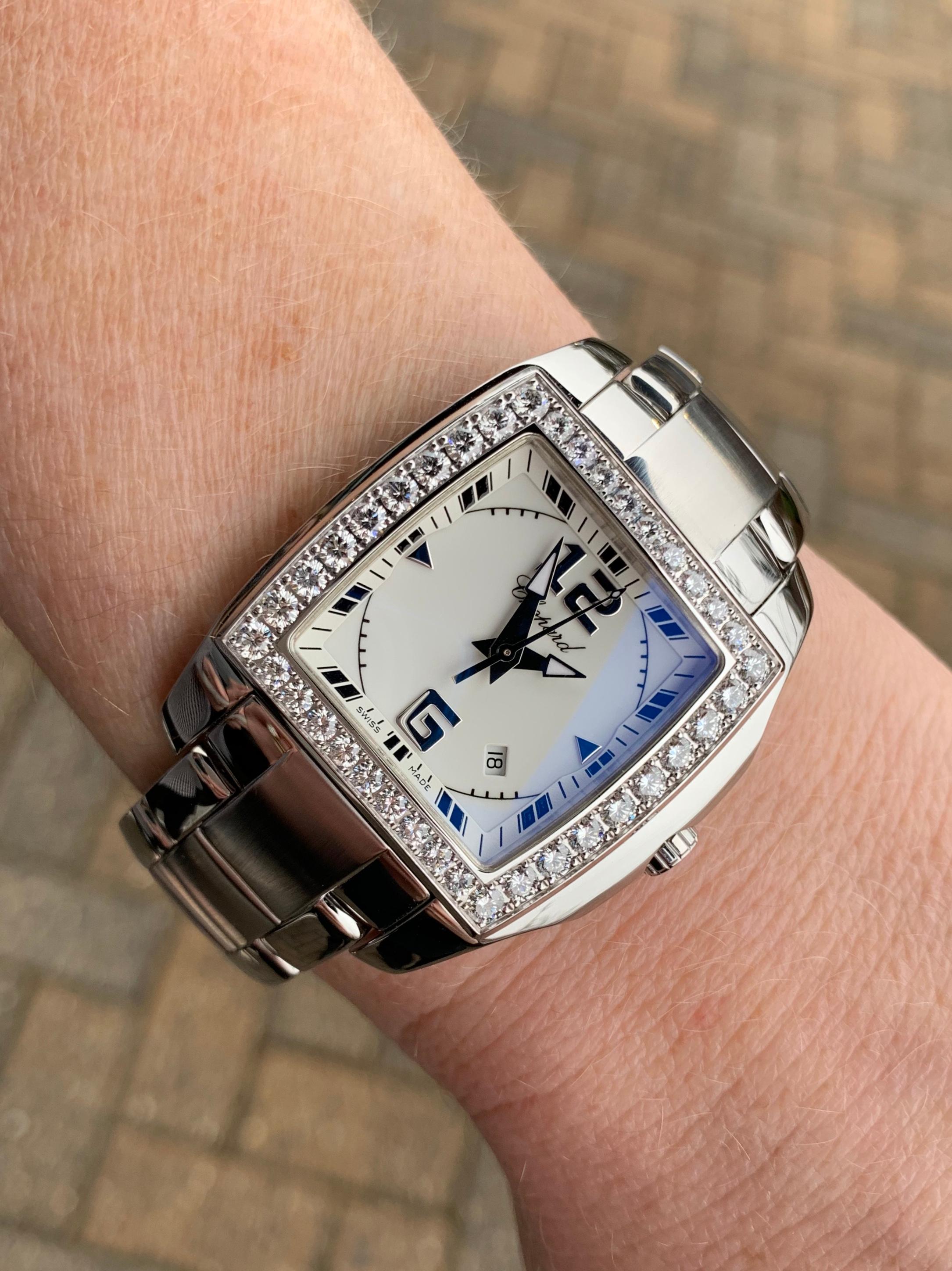 An iconic design by Chopard, the Two-O-Ten timepiece with 18k white gold case adorned with 38 round brilliant diamonds on the bezel at 1.87 carats total weight. Diamond quality is colorless and eye clean. Watch case is an attractive tonneau shape