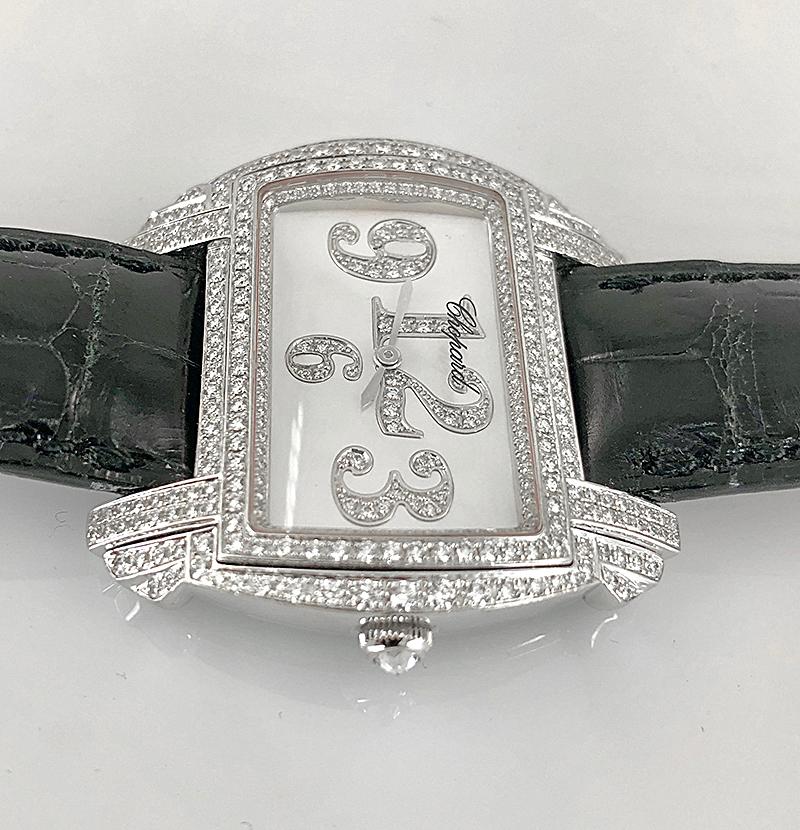 A timeless wrist watch by Chopard, crafted in 18k white gold, a black leather strap, the face set with a frame of  brilliant diamonds and a mother of pearl dial with diamond filled numbers, signed Chopard.