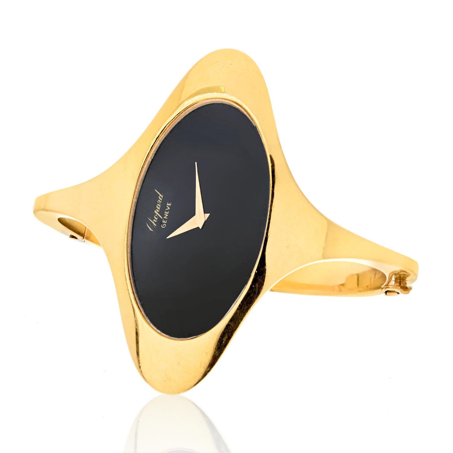 Presenting a stunning piece of horological history: a vintage 18K gold bangle bracelet watch from Chopard, crafted in the glamorous 1970s. This timepiece bears the reference number 5038, and it houses a precise mechanical movement powered by manual