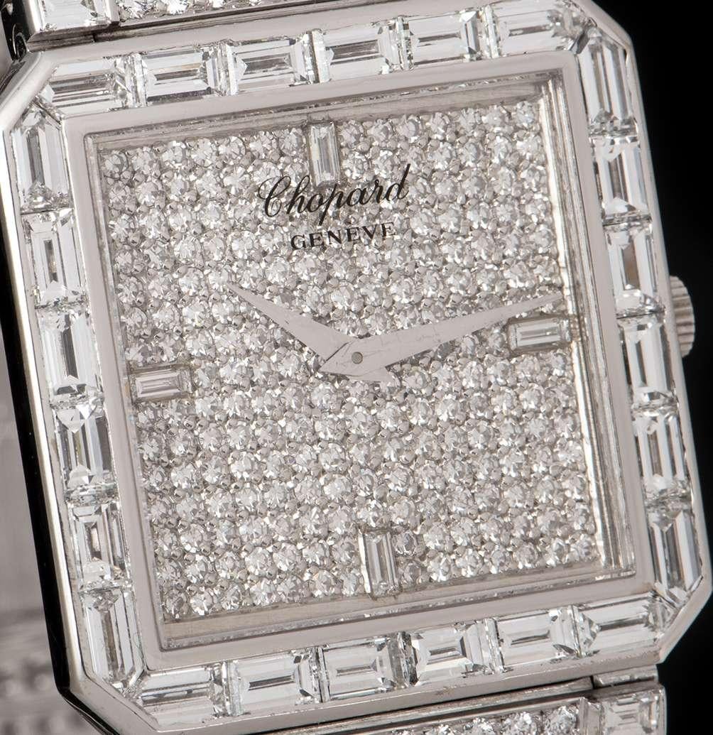 An 18k White Gold Fully Loaded Ladies Wristwatch, pave diamond dial set with approximately 216 round brilliant cut diamonds (~1.43ct) and 4 baguette cut diamond hour markers (~0.13ct), a fixed 18k white gold bezel set with 24 baguette cut diamonds,