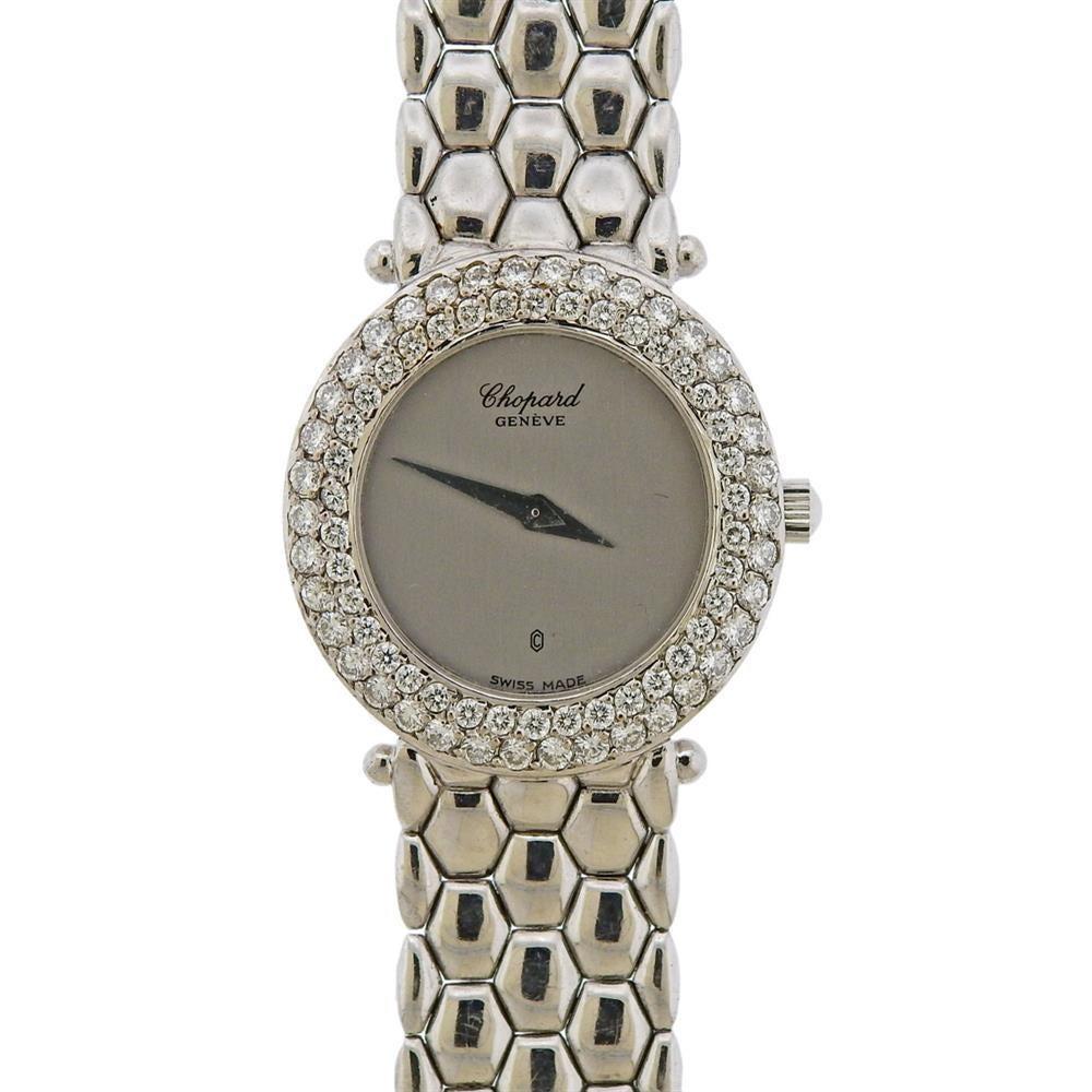 Classic 18k white gold Chopard watch, set with approx. 0.90ctw in diamonds on the bezel. Chopard silver tone dial with silvered hands. 18k gold band is 7 1/8