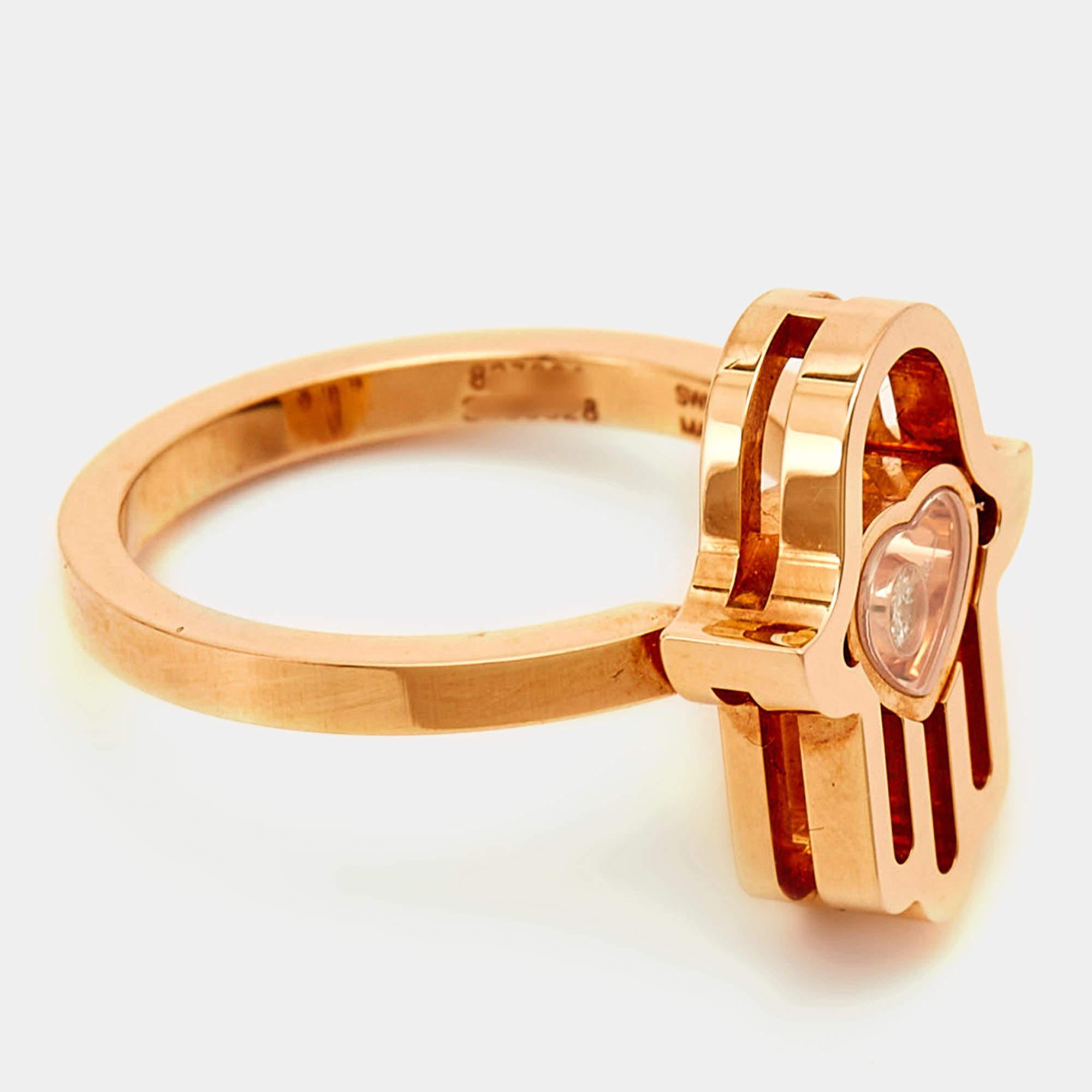Dieser Chopard Good Luck Charm Hamsa Hand Diamantring ist aus 18 Karat Roségold gefertigt. Das Highlight des Designs, die HAMSA-Hand, besteht aus einem Herzmotiv, das einen schwebenden Diamanten umschließt. Dieser schlichte und süße Ring kann Ihr