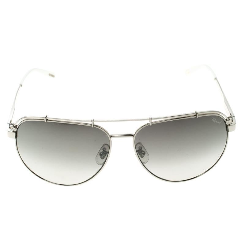 A stunning pair of aviator sunglasses from Chopard, this piece of accessory is perfect to create the most stylish smart and chic look. A beautiful pair of the aviator is a must have in every woman’s collection and this piece features silver titanium