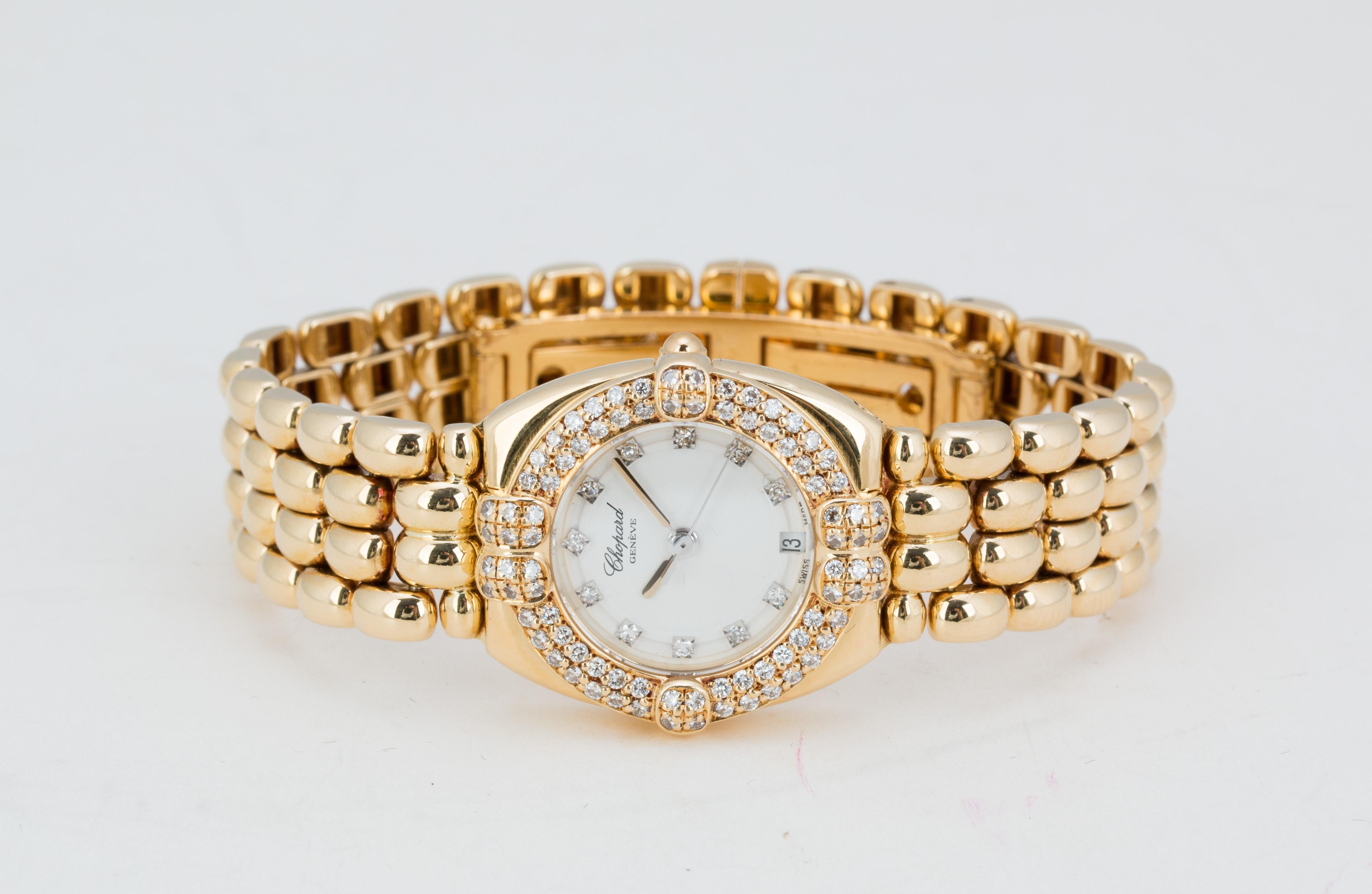 Authentic Chopard 'Gstaad' 18 karat yellow gold ladies watch with diamond bezel. Bezel is set with an estimated 0.75 carats of round brilliant cut diamonds (F-G in color, VS-SI clarity). Watch features a white face set with 12 diamond markers and a