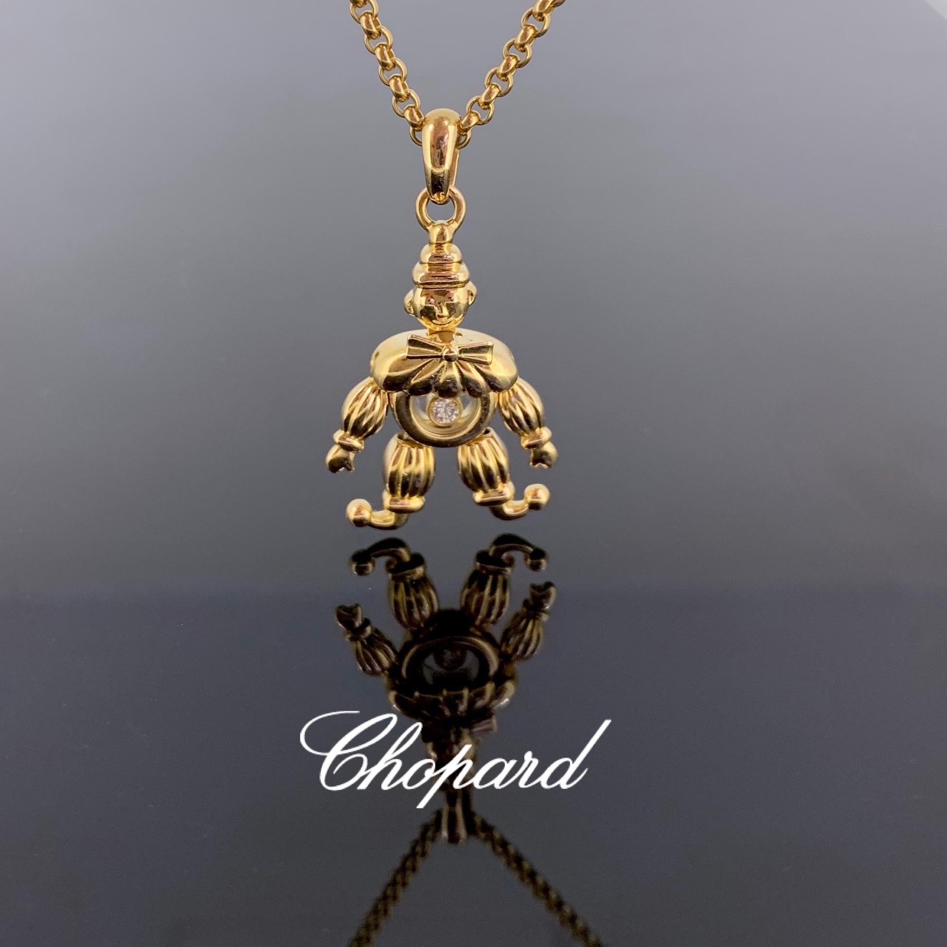 This whimsical pendant features a friendly clown with a crystal case body containing a brilliant cut diamond, floating in the case. Its hands and feet move. It is signed Chopard on the back and on the front glass. It comes with its chain, which is