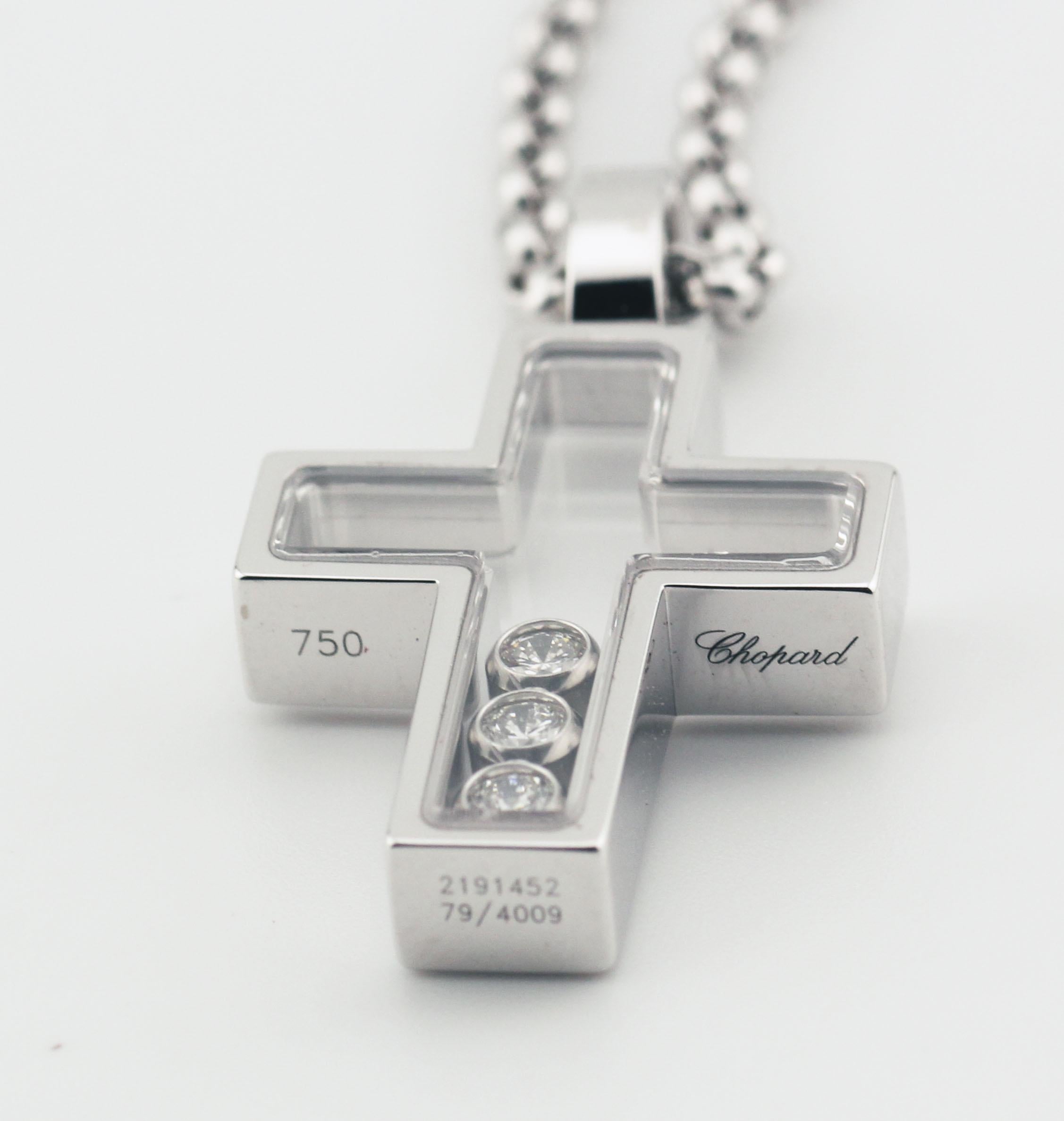 The Chopard Happy Diamond 18k White Gold Cross Pendant Necklace is a luxurious piece that beautifully combines timeless symbolism with the brand's signature playful elegance. Crafted from 18k white gold, this necklace exudes a sleek, modern