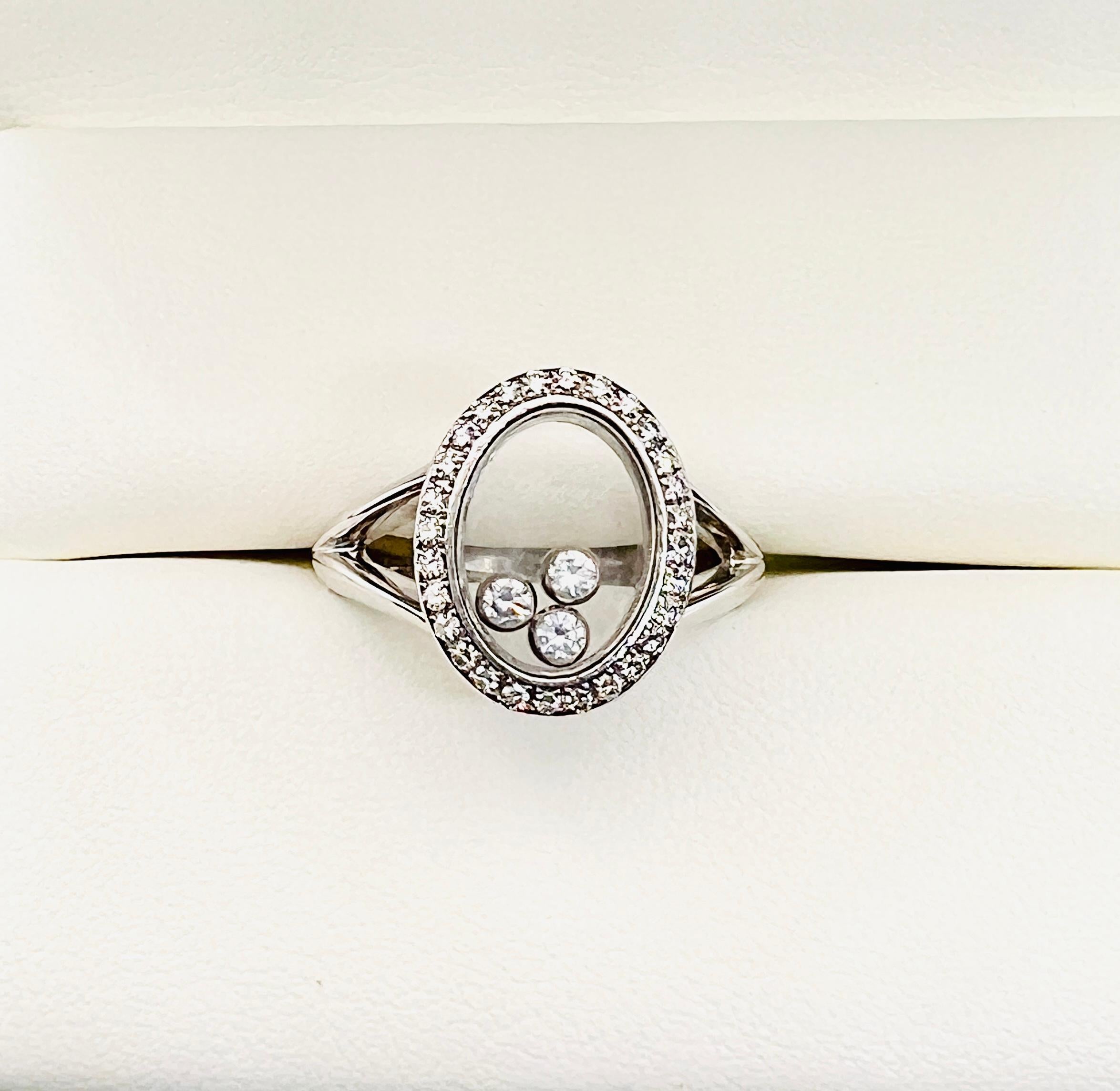Gorgeous Chopard Happy Diamond Ring! Made in 18K White gold that features a split shank. The oval has three bezel set floating diamonds that are surrounded by a 27 diamond halo. The ring weighs 7.7 grams and is  size 7.75. The floating diamond move