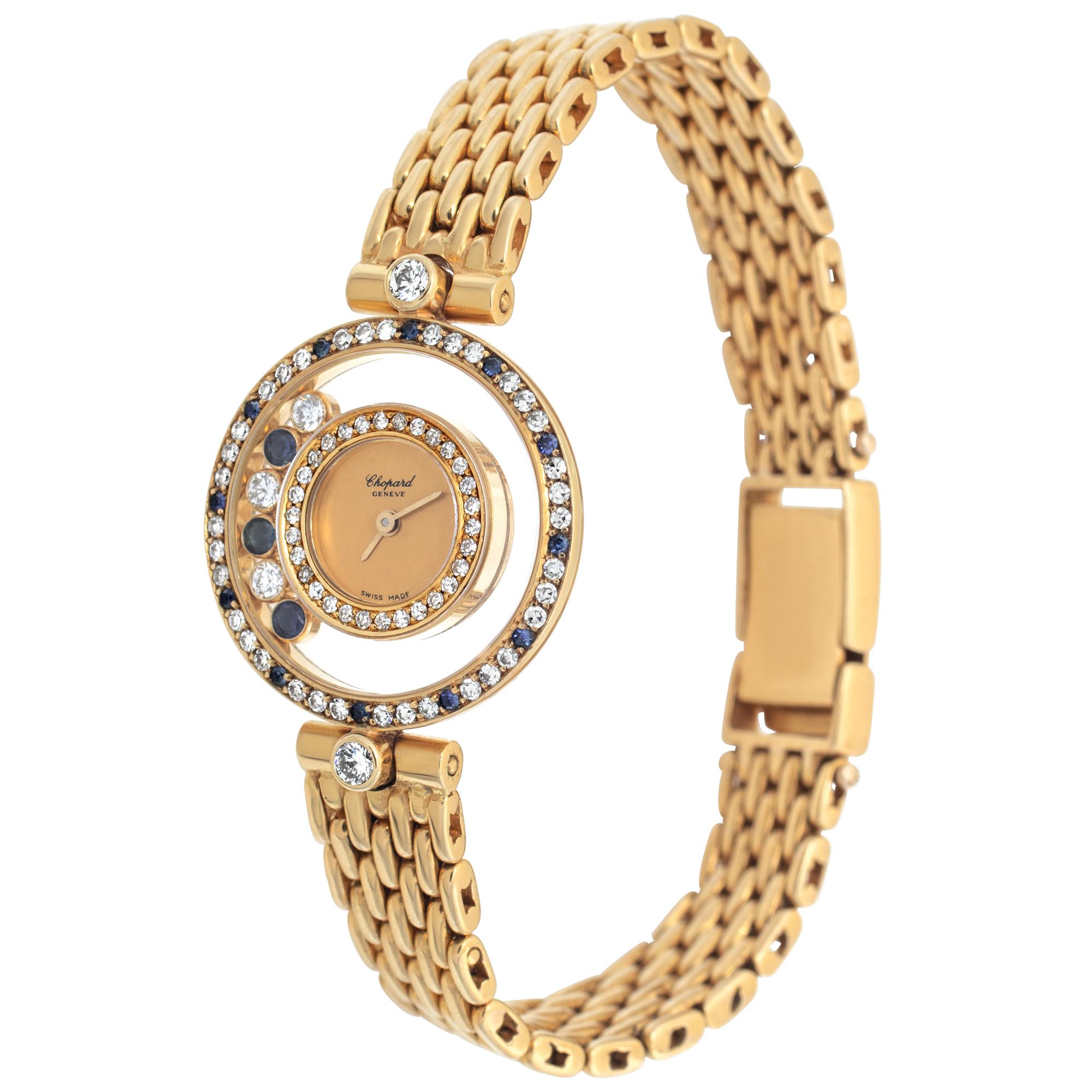 Chopard Happy Diamond in 18k yellow gold with diamonds and sapphire bezel and floating diamonds and sapphire accents. Quartz. 24 mm case size. Ref 295084103. With Chopard gold pusher, extra black leather strap, and booklets. Fine Pre-owned Chopard