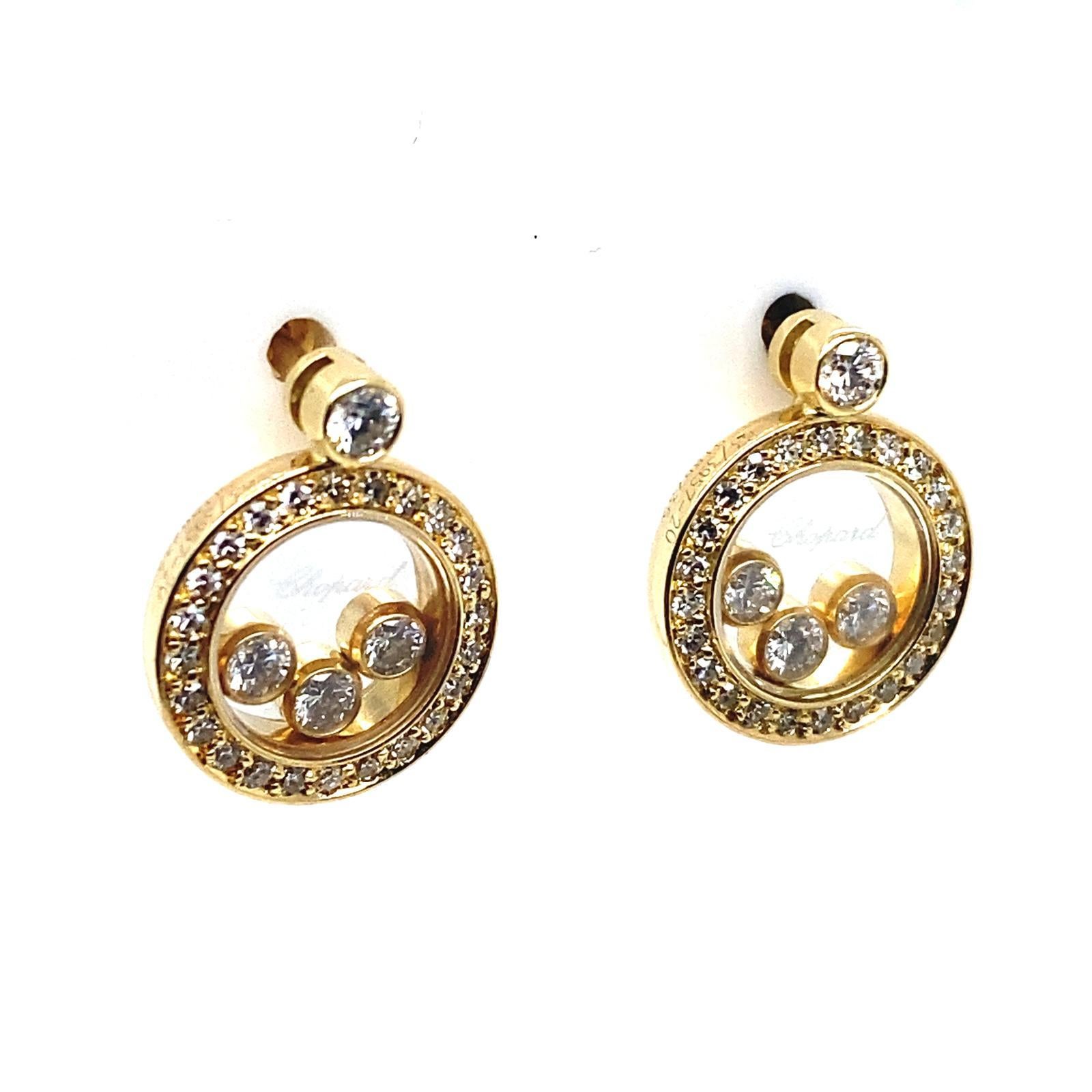 A pair of Chopard Happy Diamond circle 18 karat yellow gold earrings.

These elegant circle shaped stud earrings are from Chopard's signature Happy Diamond collection.

Both earrings contain three of Chopard's iconic floating diamonds each