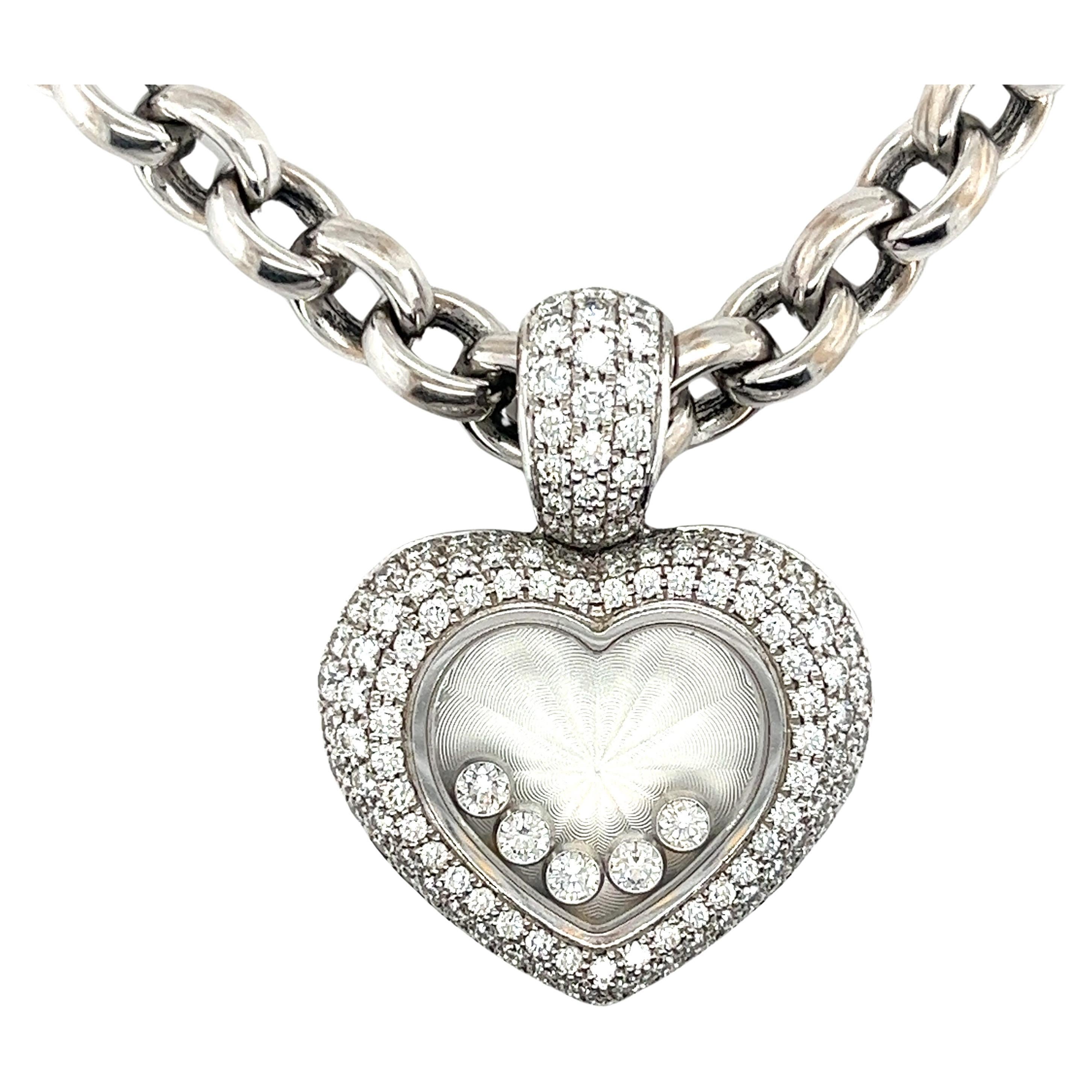 Chopard Happy Diamond floating diamond heart-shaped pendant necklace in 18k white gold. Complete with the original Chopard pouch and receipt papers. 

This pendant necklace features 5 floating diamonds that dazzle and dance in the pendant as you