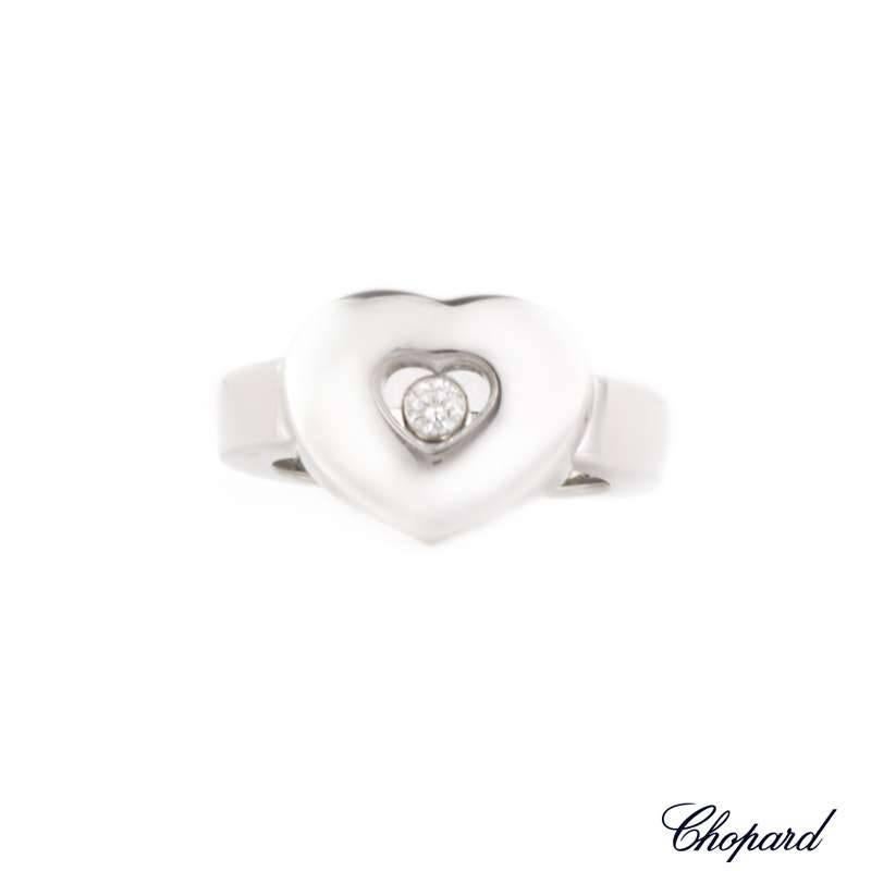 A Chopard Happy Diamonds ring set in 18k white gold. The ring is made up of a heart design centred with the signature floating diamond weighing 0.10ct. The ring is approximately 4mm wide and is a size EU 52, US size 6, but can be adjusted for a