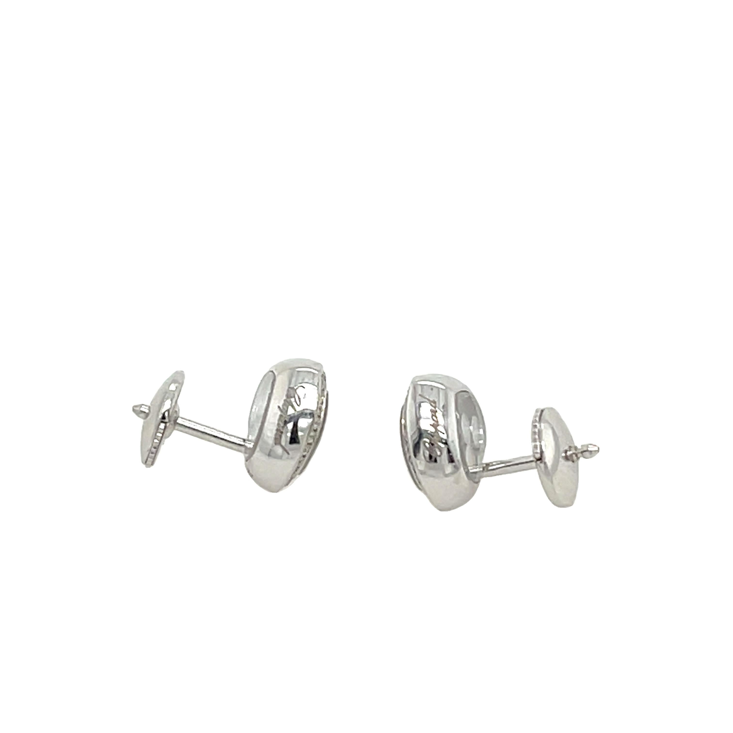 Timeless elegance meets playful luxury with these authentic Chopard Happy Diamond Heart Earrings. Crafted in 18ct yellow gold, each heart-shaped stud features a crystal window enclosing three floating brilliant-cut diamonds, dancing freely with your