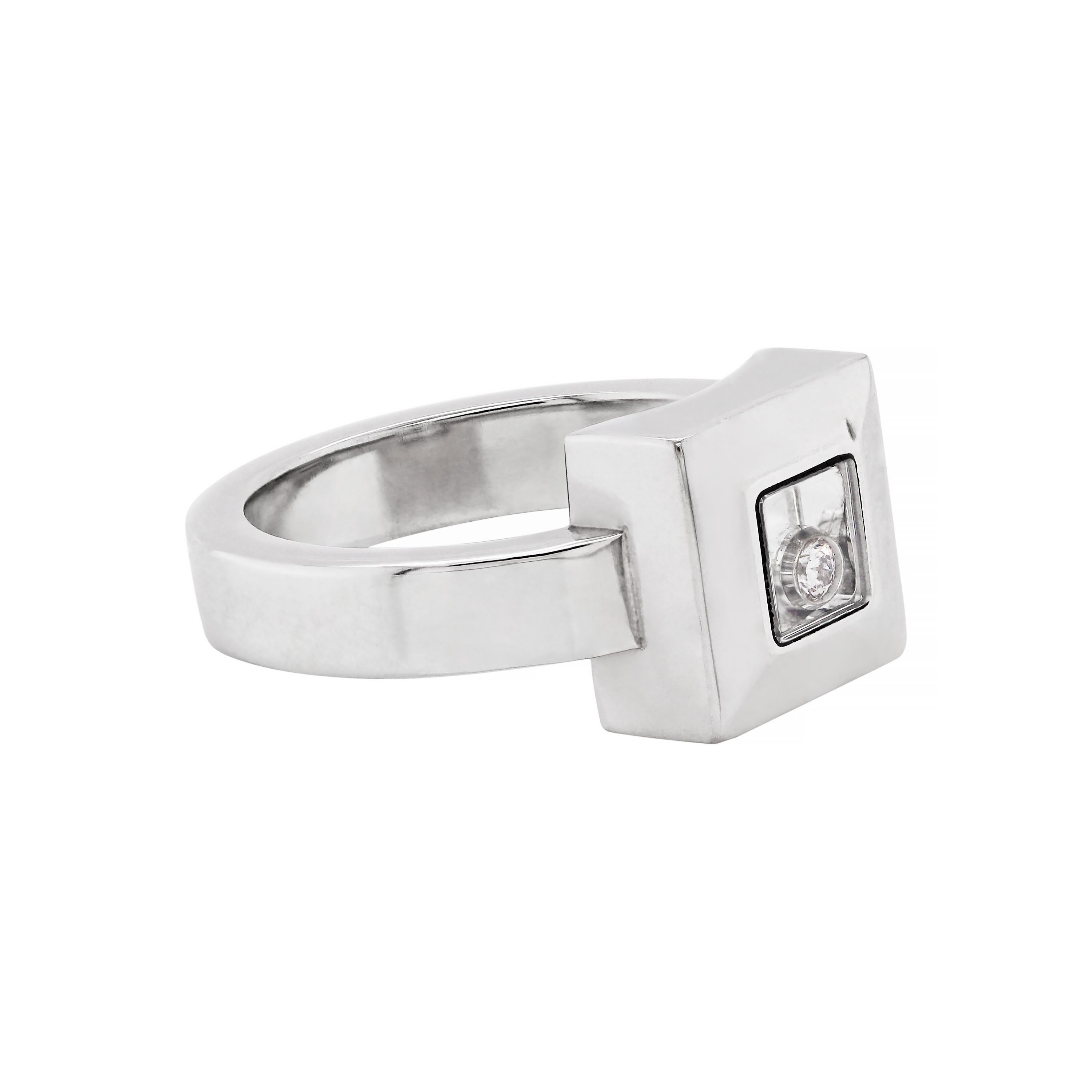 This beautiful Chopard Happy Diamond Icons ring is crafted from 18 carat white gold and features an elegant square frame measuring 1 x 1cm. The Chopard's signature mobile 'happy diamond' is placed between a pair of sapphire crystals which are set in