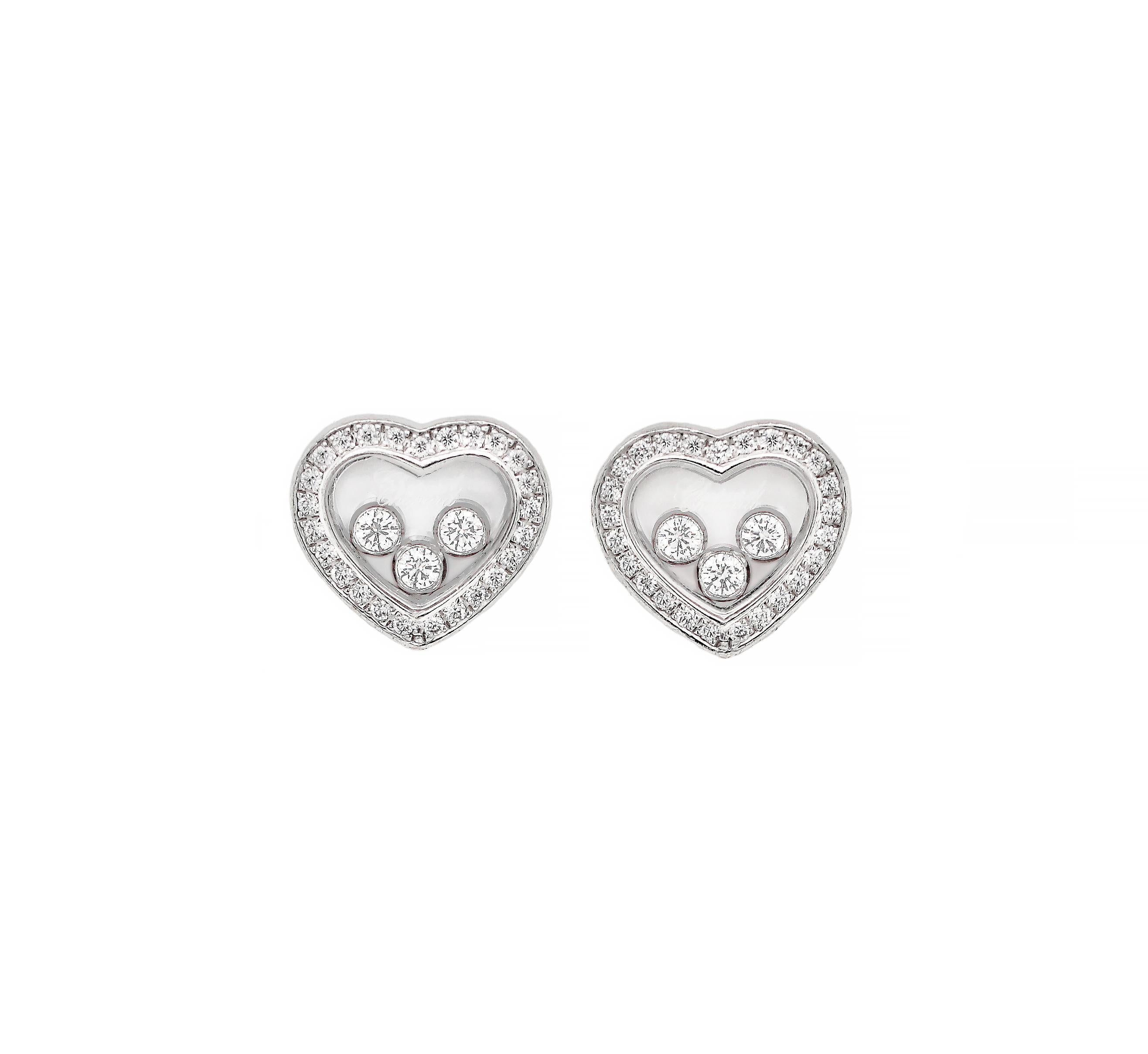 Beautiful heart shaped earrings from Chopard's signature Happy Diamond collection each pavé set with 25 round brilliant cut diamonds on each heart. The earrings then feature 3 freely-moving round brilliant cut diamonds encased between two sapphire