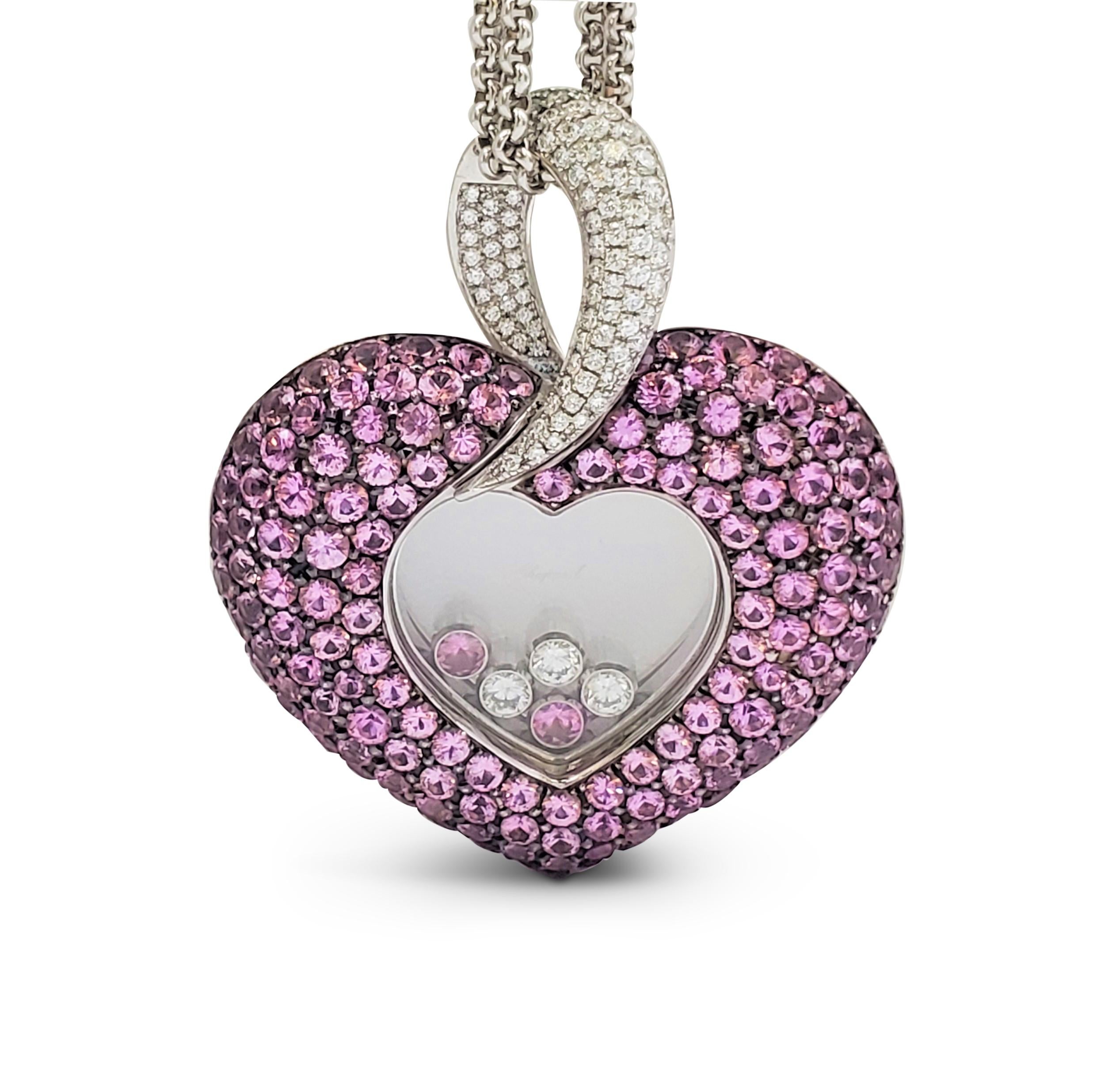Authentic delightful Chopard 'Happy Diamond' heart-shaped pendant necklace crafted in 18 karat white gold. The puffed pendant is set with gemmy pink sapphires and sparkling pave set round brilliant cut diamonds at the bail. Three floating diamonds