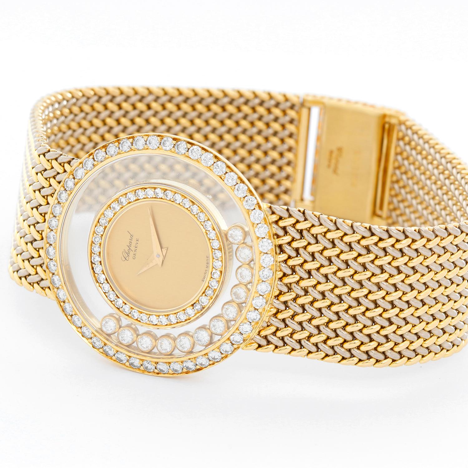 Chopard Happy Diamonds 18K Gold Ladies Watch - Quartz. 18K yellow gold case with pave-set diamond bezel; two glazed plated containing 12 free floating diamond collets ( 32 mm ). Champagne dial. Mesh 18K yellow gold bracelet. Pre-owned with Chopard