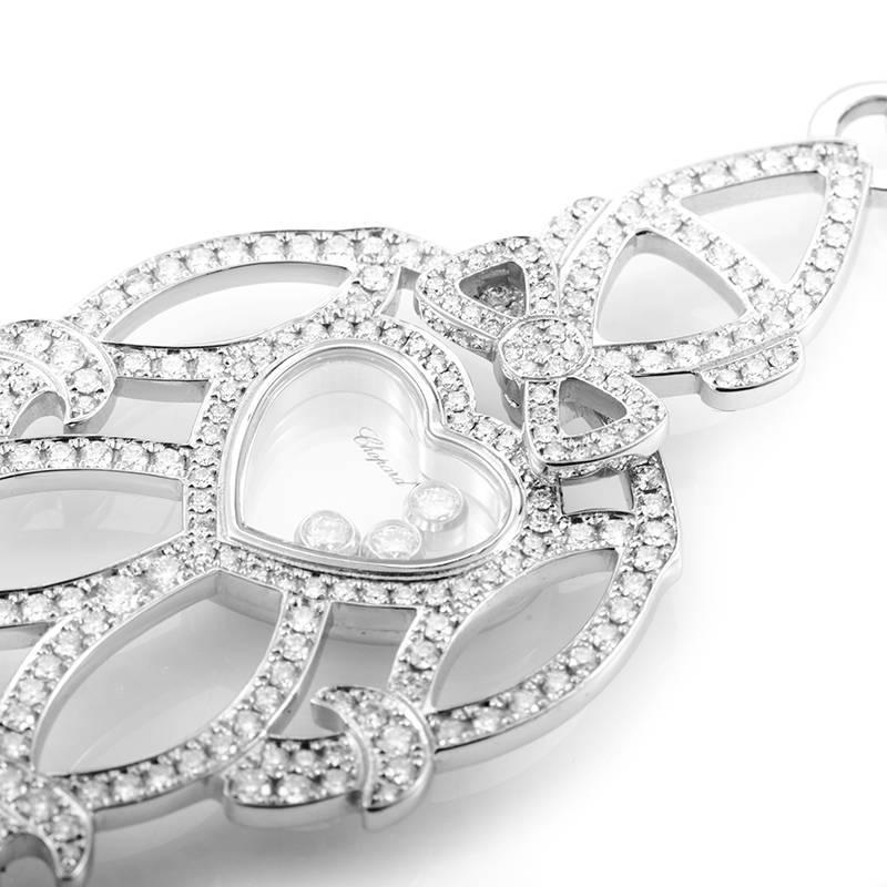 A charming jewelry piece from Chopard made of elegant 18K white gold, boasting a creatively designed and well-made pendant paved with diamonds, with transparent heart-shaped center into which three gorgeous diamond stones are placed. Total diamond