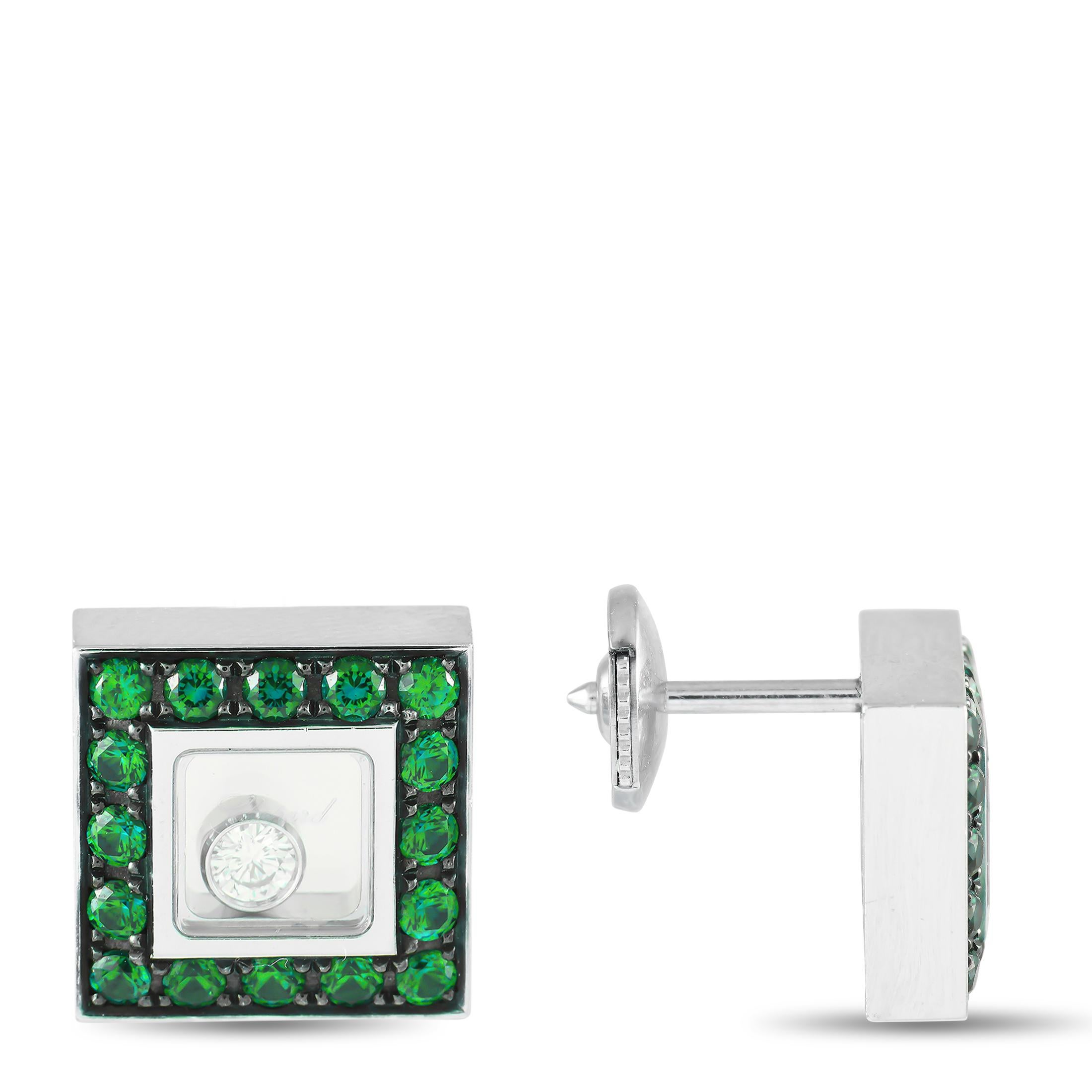Here is a beautiful pair of earrings from Chopard's innovative Happy Diamonds collection. These earrings are made from 18K white gold and showcase an unconventional box-like silhouette. The square studs have a unique sapphire enclosure at the
