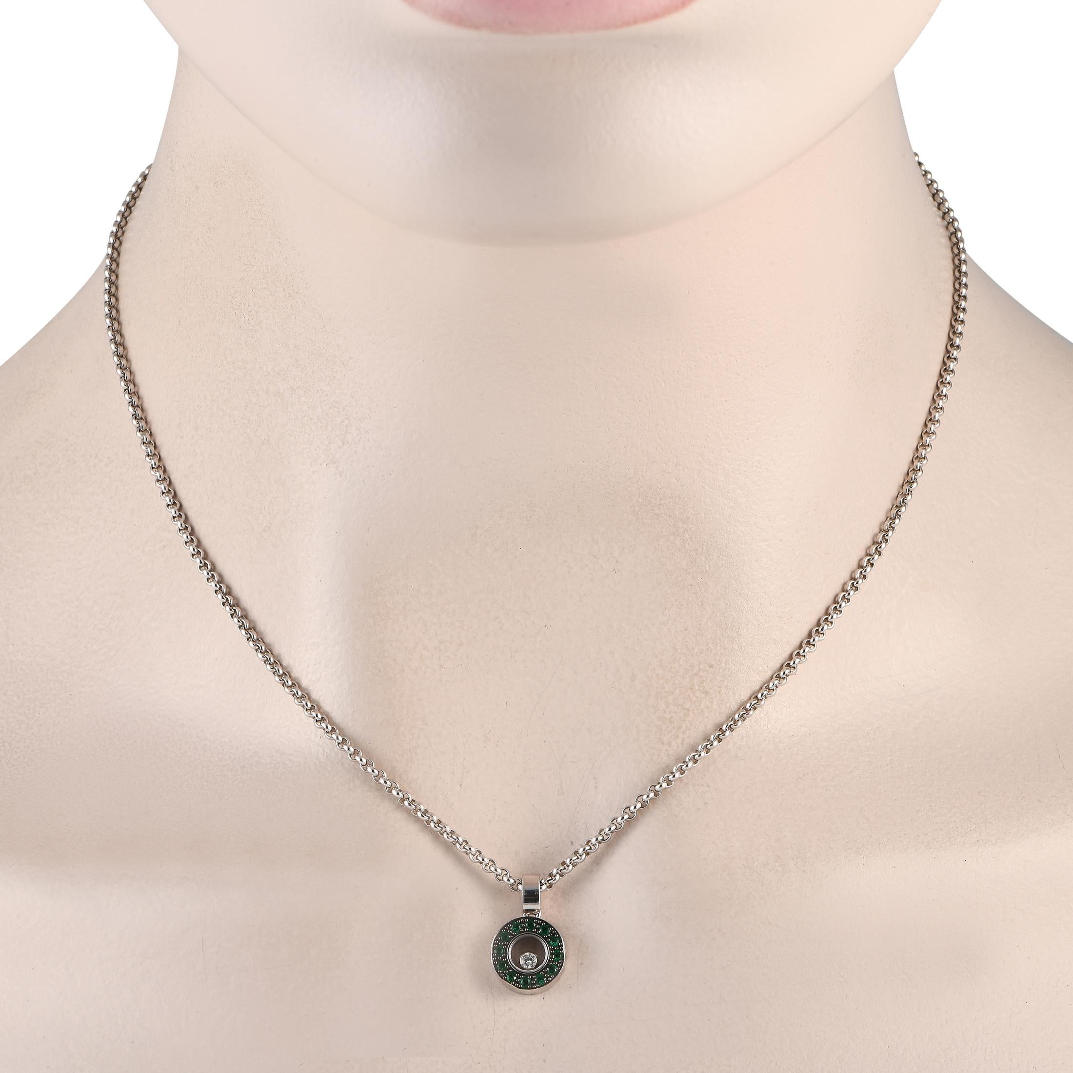 From Chopard's Happy Diamonds collection, here is a daring and playful yet elegant necklace that will bring personality to your style. It features a round pendant with a circular frame of emeralds. At the center are two panes of sapphire crystals,