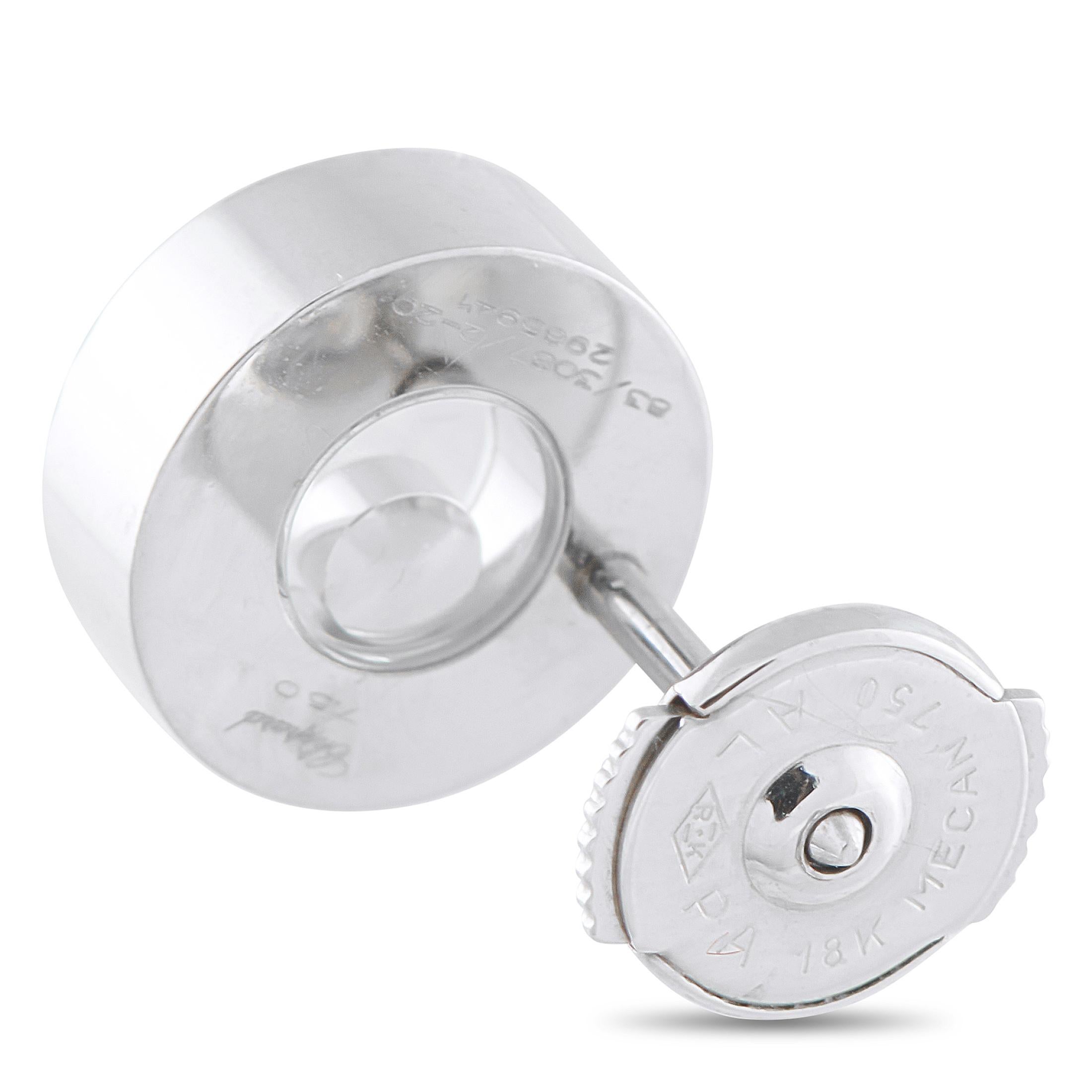 Crafted in gleaming 18K white gold, these Chopard earrings offer a beautiful contrast of dark color, vivid green, and perpetual sparkle. The design centers on a single bezel-set round diamond, set within two sapphire crystals and designed to move